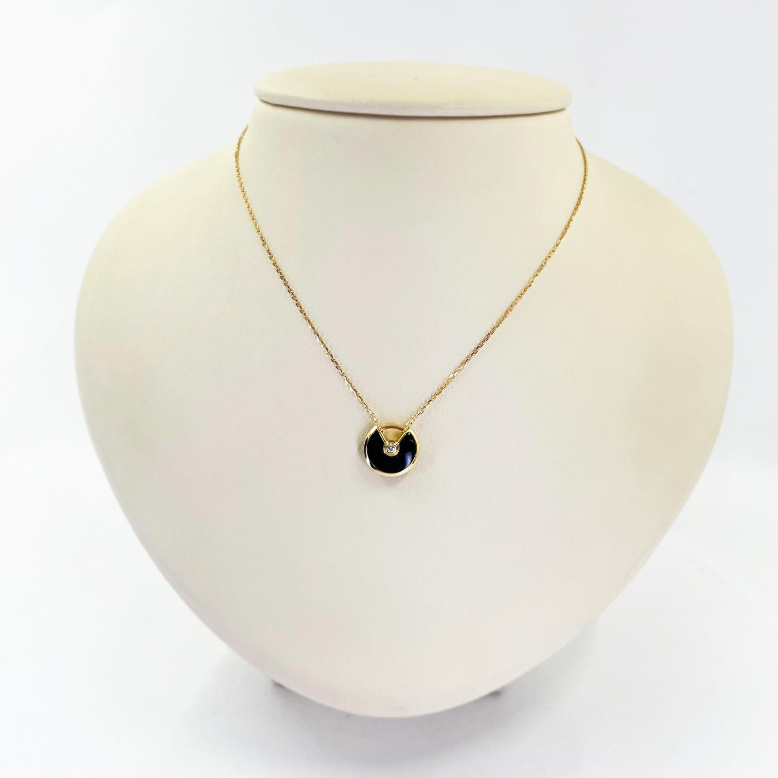 Cartier 18 karat rose gold Amulette pendant necklace featuring onyx design accented by a 0.02 carat round brilliant cut diamond of VS clarity and F/G color.  Adjustable length 15 -16 inches. MSRP $2,010.
