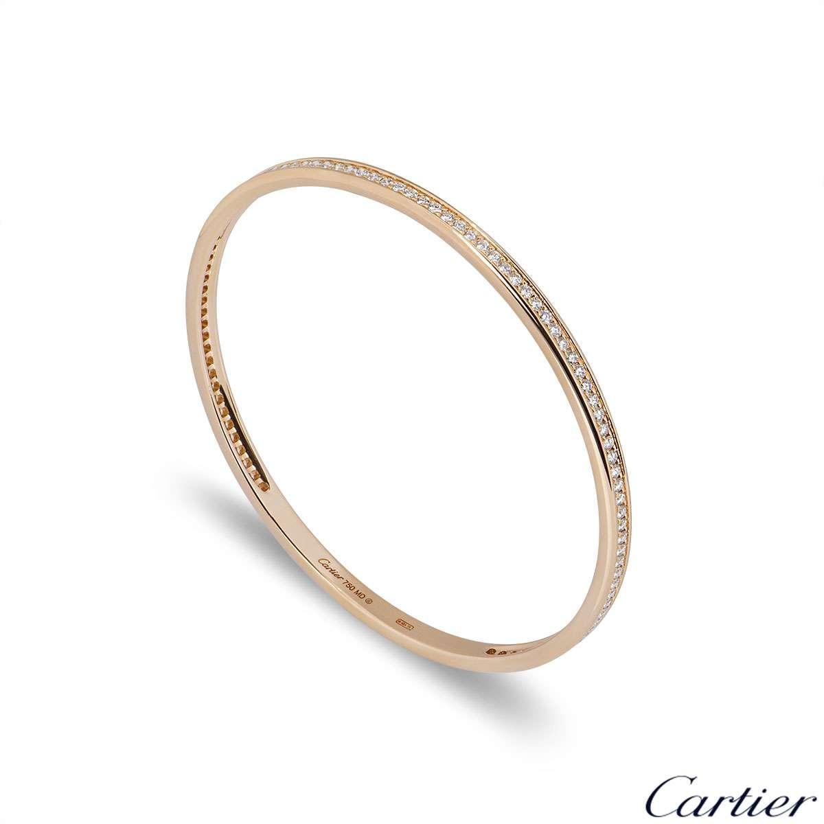 An 18k rose gold diamond set bangle by Cartier. The bangle features approximately 114 round brilliant cut diamonds totalling 2.28ct. The 3.8mm wide bangle has a circumference of 19.5cm and has a gross weight of 18.7 grams.

The bangle comes complete