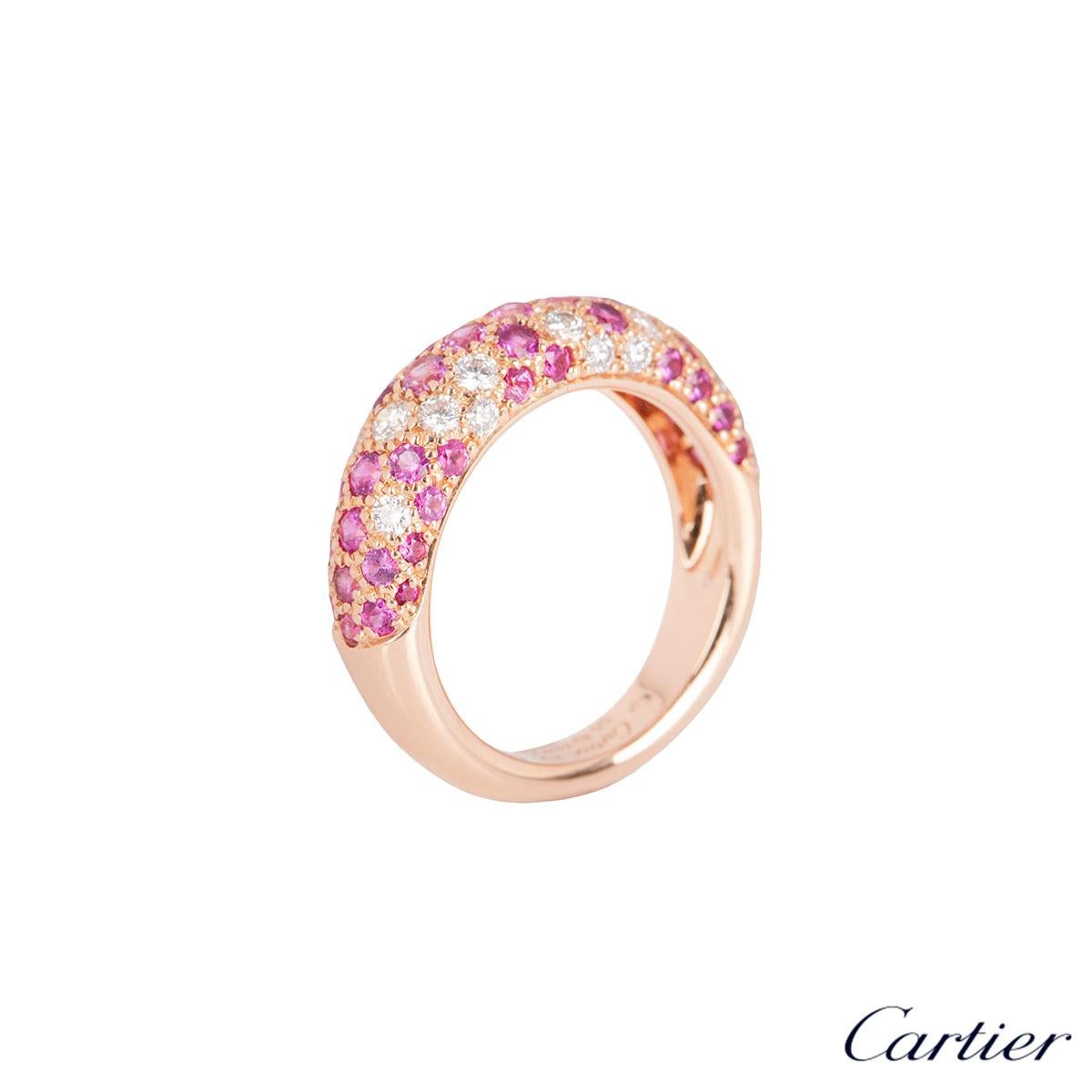 An 18k rose gold diamond and sapphire ring by Cartier from the Etincelle collection. The ring comprises of pave set pink sapphire and round brilliant cut diamonds alternating in formation half set across the band. The diamonds have an approximate