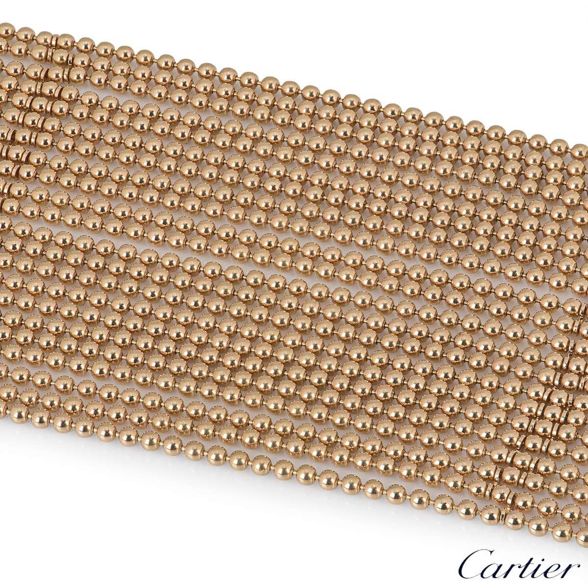 A stylish 18k rose gold bracelet from the Draperie collection by Cartier. The bracelet has 22 flexible beaded strands which terminate with 6 button loop closures. The bracelet measures 2 inches in width and 7.5 inches in length, with a gross weight