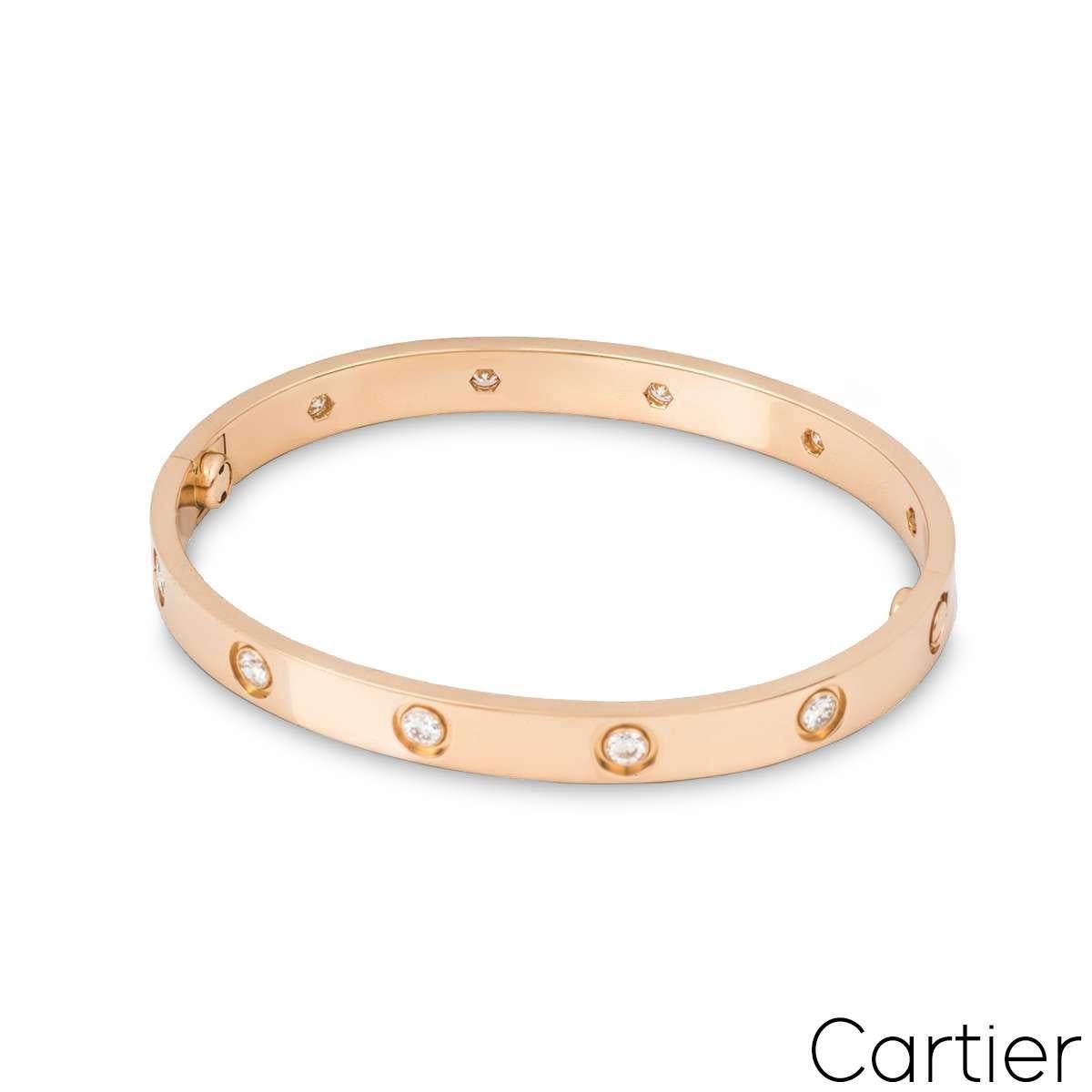An 18k rose gold, full diamond Love bracelet by Cartier. Set with 10 round brilliant cut diamonds circulating the outer edge, totalling 0.96ct. The bracelet features the new style screw fitting, is a size 17, measures 6.1mm in width and has a gross