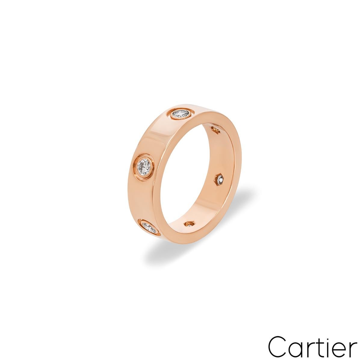 An iconic 18k rose gold Cartier ring from the Love collection. The ring comprises of 6 round brilliant cut diamonds set throughout the centre of the band with an approximate total weight of 0.46ct, F-G colour and VS clarity. It measures 5.5mm in