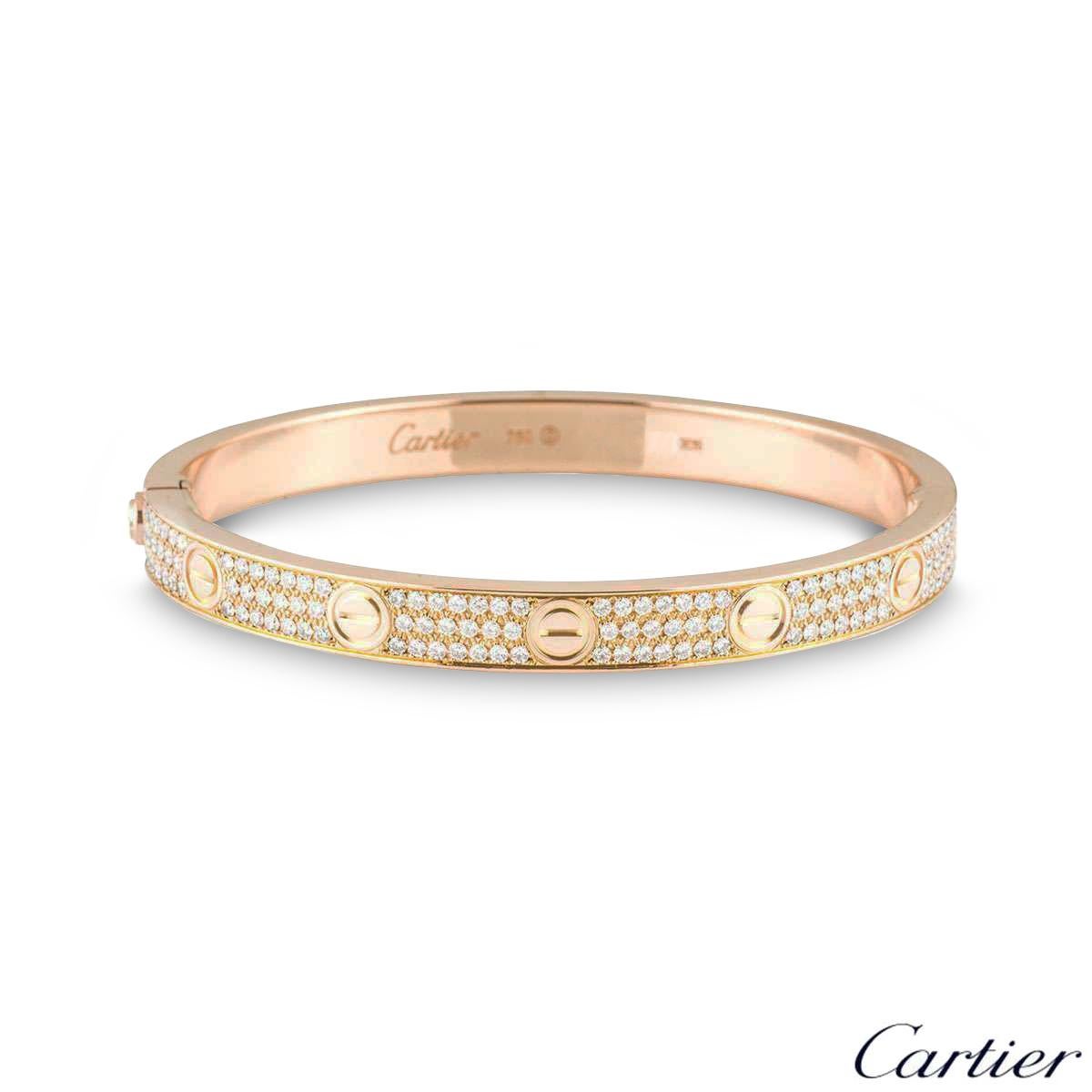 A sparkly 18k rose gold diamond Cartier bracelet from the Love collection. The bracelet comprises of the iconic screw motif on the outer edge complemented with 204 round brilliant cut diamonds throughout, in a pave setting. The diamonds have a total