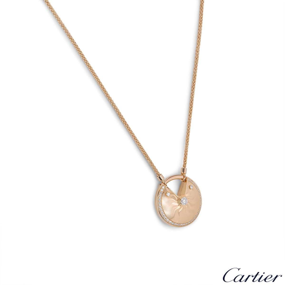 A rare18k rose gold large size necklace from the Amulette de Cartier collection. The necklace comprises of a circular talisman displaying a guilloche pattern, complemented by round brilliant cut diamonds totalling approximately 0.58ct. The talisman