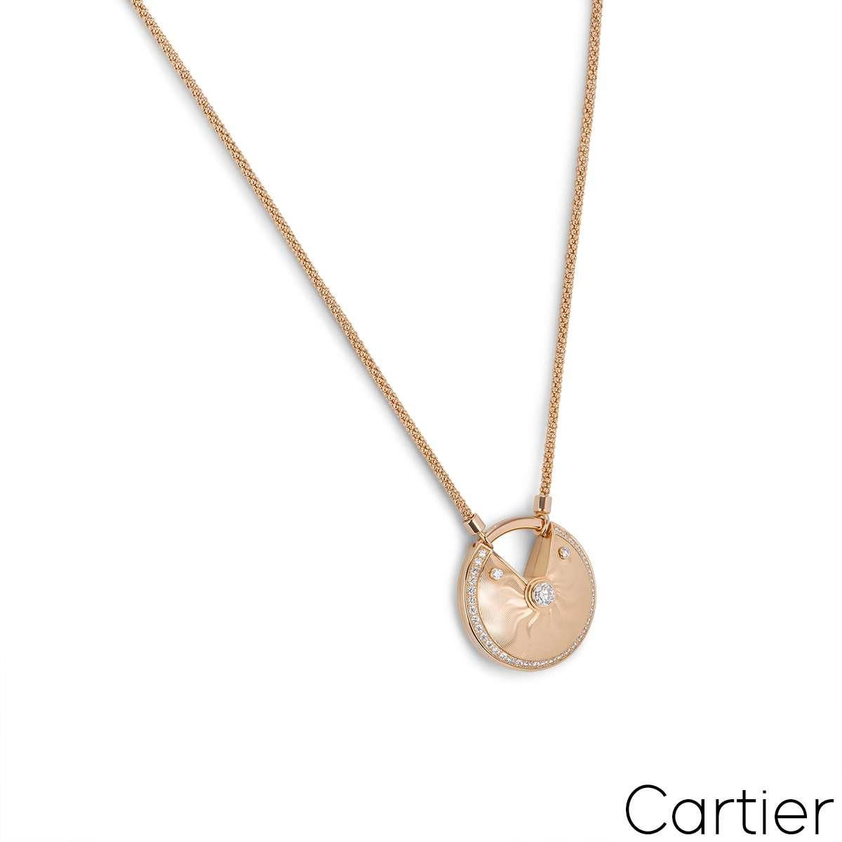 A gorgeous 18k rose gold diamond necklace by Cartier from the Amulette de Cartier collection. The necklace features a circular talisman displaying a guilloche pattern and is bezel set to the centre with a round brilliant cut diamond with an