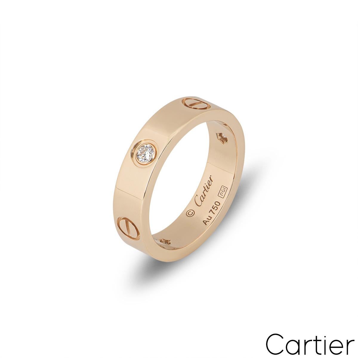 A lovely 18k rose gold ring from the Love collection, by Cartier. Set with 3 round brilliant cut diamonds in a rubover setting totalling 0.22ct, alternating between the iconic screw motif design through the centre of the band. The 5.5mm wide ring is