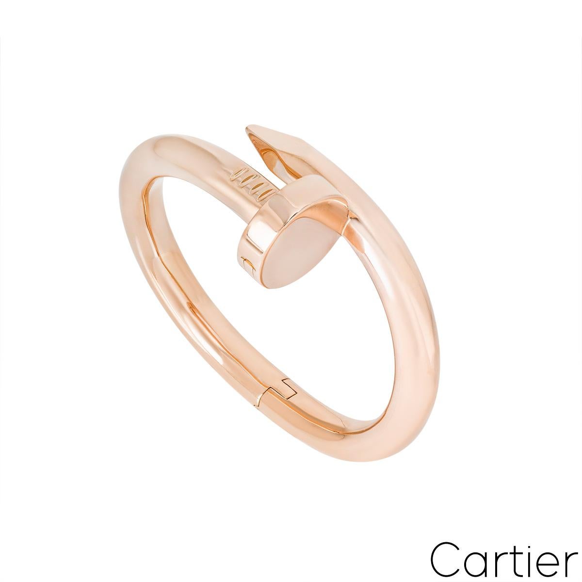 An 18k rose gold Cartier bracelet from the Juste Un Clou collection. The bracelet is a large model of the classic Juste Un Clou design, with the iconic nail head at one end and nail end at the other. The bracelet features a hinged opening with an