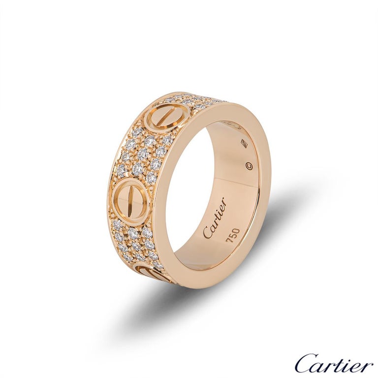 An 18k rose gold diamond ring by Cartier from the Love collection. The ring comprises of the iconic screw motifs displayed around the outer edges with 66 round brilliant cut diamonds pave set between each screw motif with a total diamond weight of