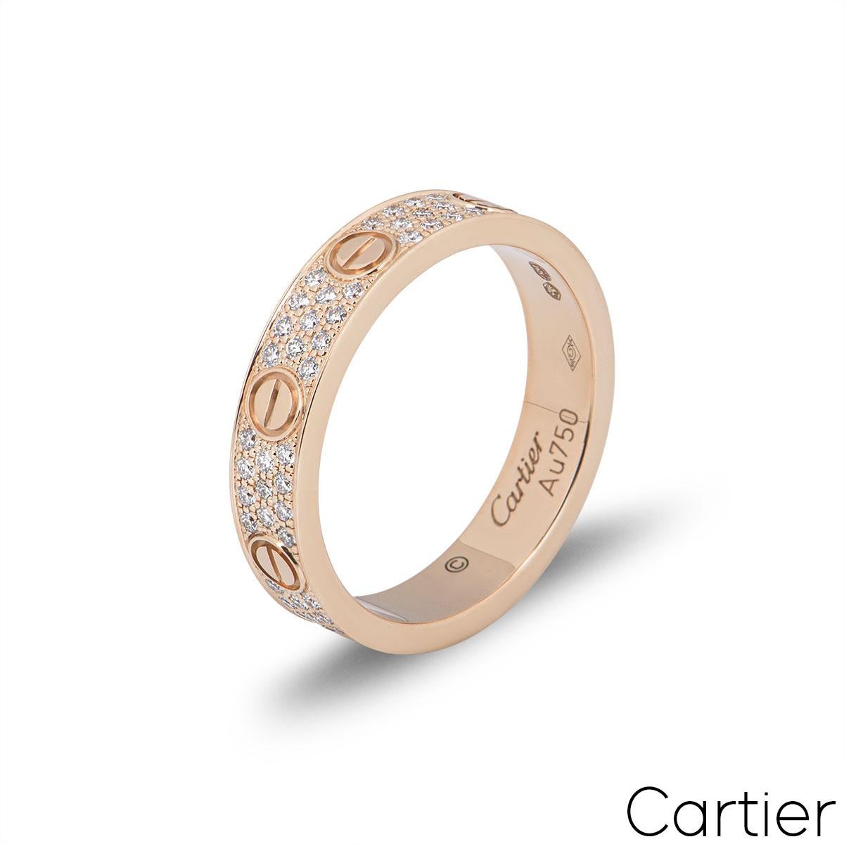 An 18k rose gold Cartier diamond pave ring from the Love collection. The ring comprises of the iconic screw motifs displayed around the outer edges with 88 round brilliant cut diamonds totalling 0.31ct set between each screw motif. The ring measures