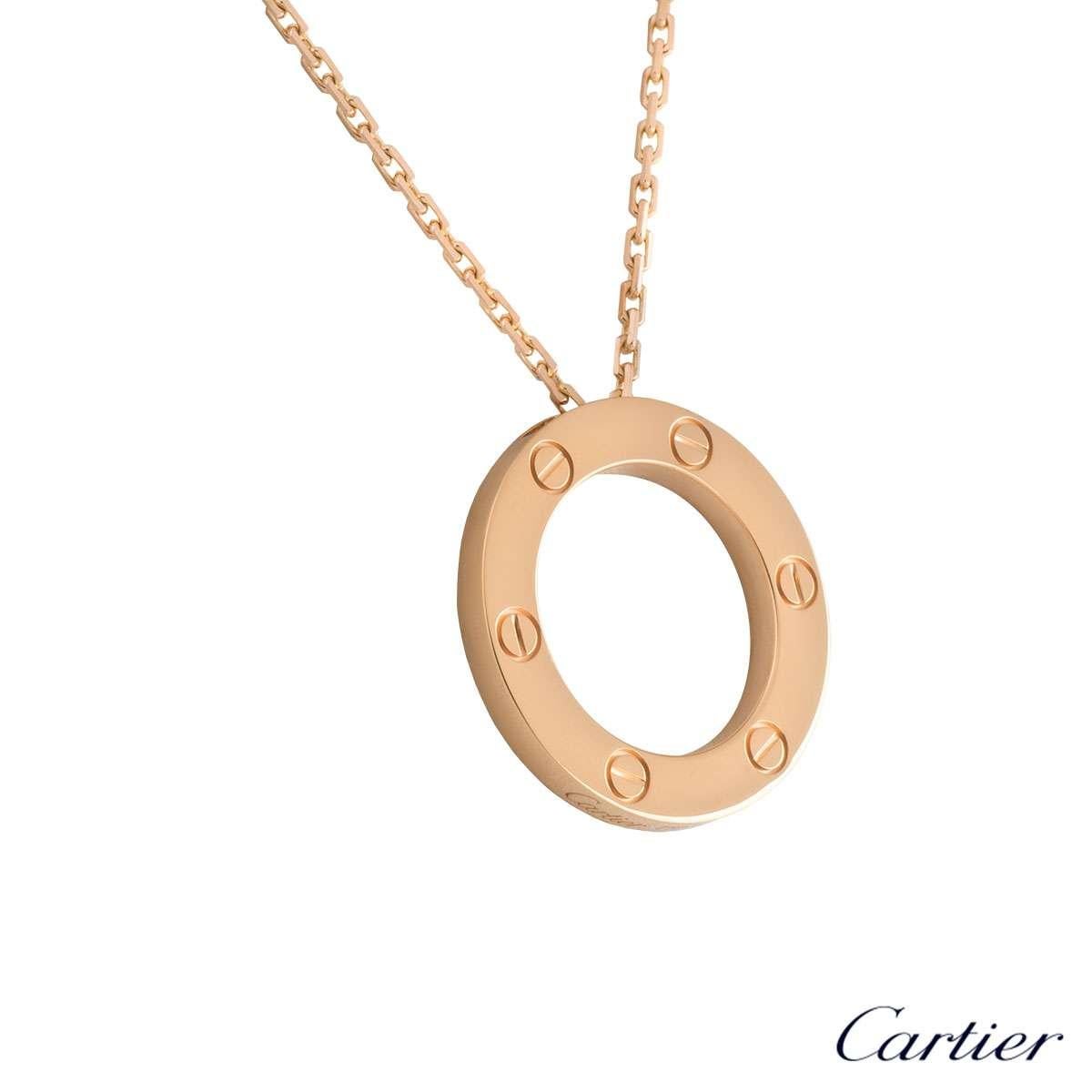 An 18k rose gold pendant from the Cartier Love collection. The pendant is composed of an open work circular motif, set to the outer edge with the iconic screw motifs. On the reverse of the pendant the word 'Love' is engraved to the bottom. The