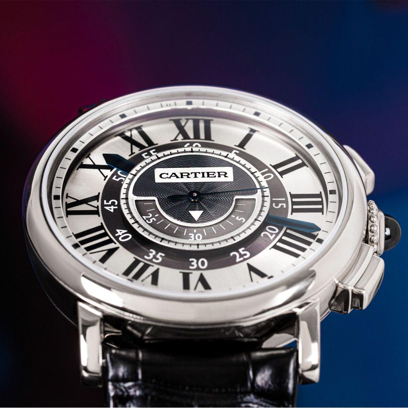 A mens Rotonde de Cartier in white gold. Featuring a distinctive slate grey dial with roman numerals, arabic minute markers, blued steel sword shaped hands and Cartier's own hidden signature at VII. Complementing the dial is a fixed white gold bezel
