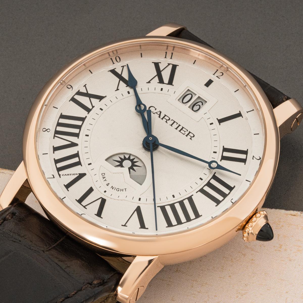A 42mm Rotonde De Cartier wristwatch crafted in rose gold. Featuring a silver guilloche dial with roman numerals, a large date display, a second-time zone function and day/night indicators. Fitted with a sapphire glass, a self-winding automatic