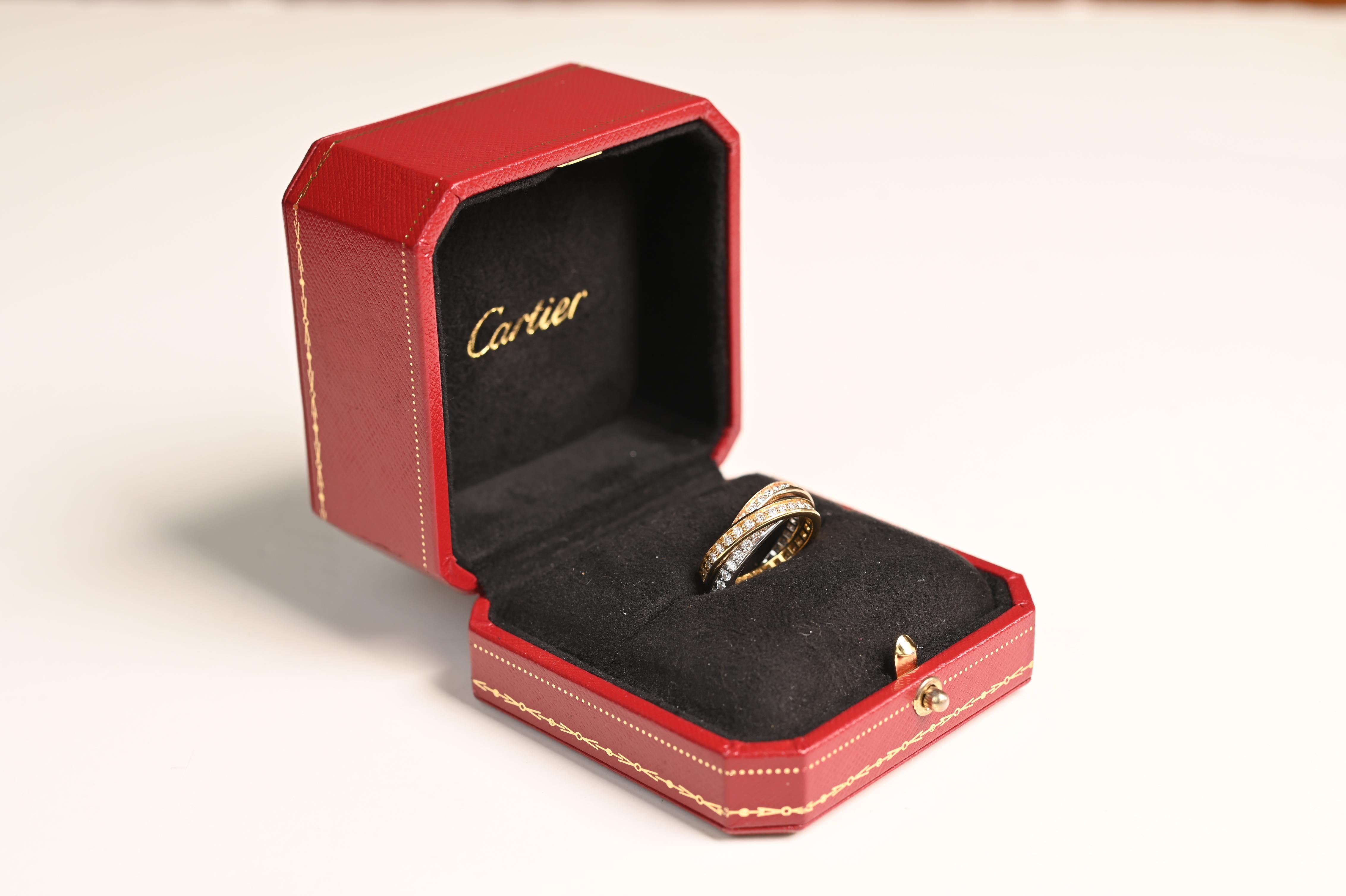 This exquisite Cartier rolling ring is a true masterpiece of fine jewelry. Comprising three interwoven bands of 18k yellow, white, and rose gold, this iconic design symbolizes unity and timeless elegance. Each band is adorned with a full circle of