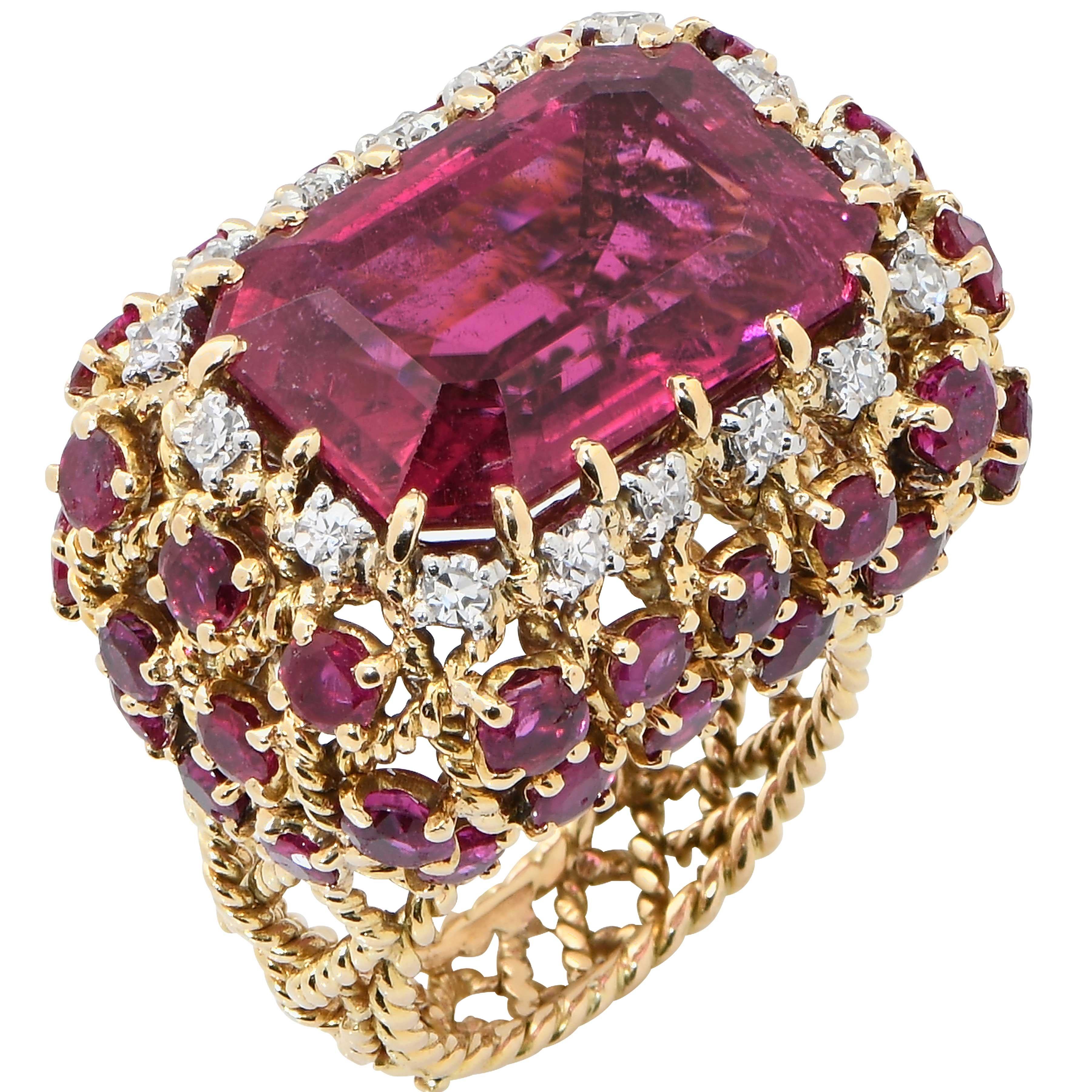 Cartier Rubellite, Diamond and Ruby Ring in 18 Karat Yellow Gold with Platinum Accents. This Ring Features an Emerald Cut Rubellite with an Estimated Total Weigh of 13 Carats Surrounded by Single Cut Diamonds and Round Cut Rubies. 
Very good