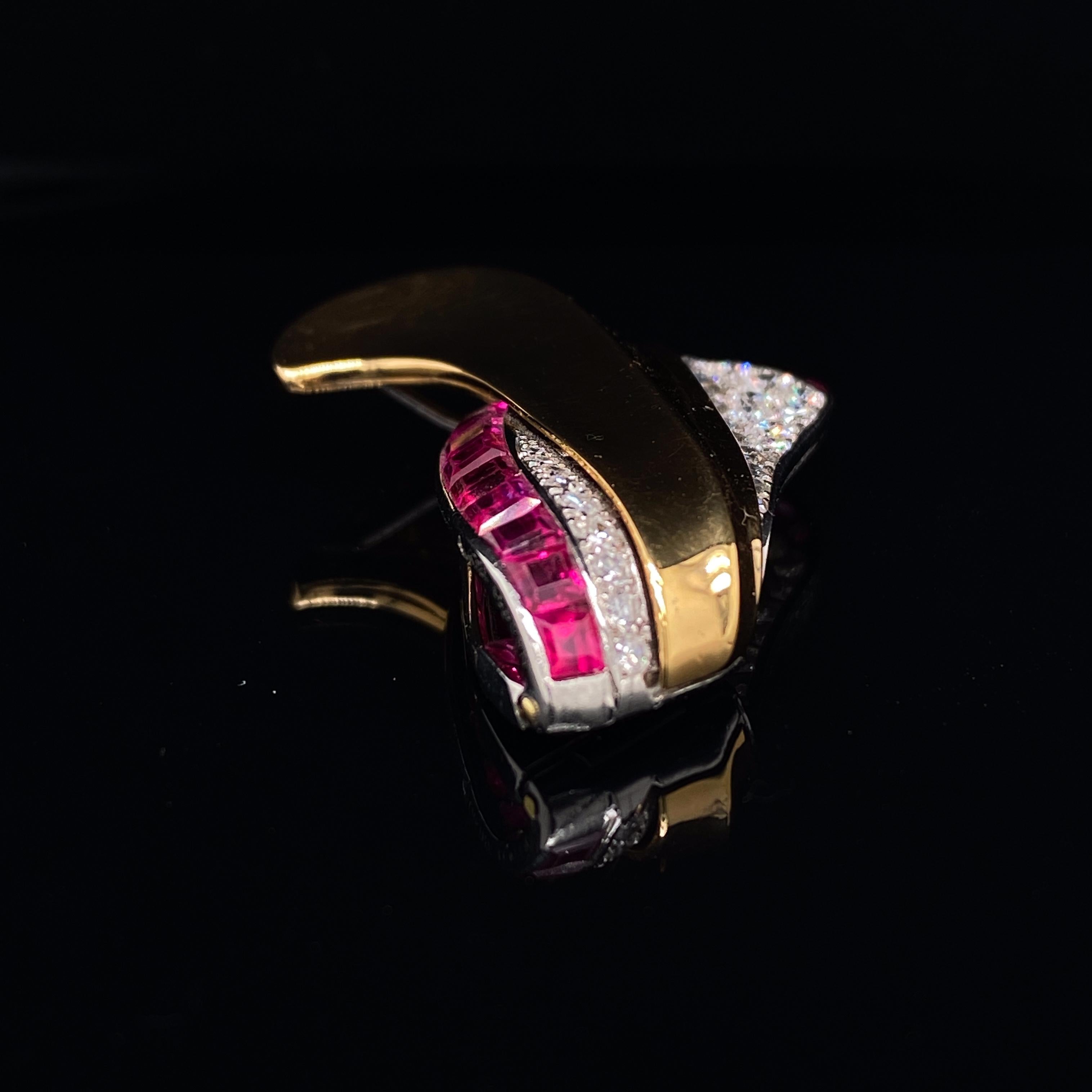 Cartier ruby and diamond 18 karat yellow gold brooch circa 1950.

This elegant brooch comprises of calibre cut rubies set within a fine platinum border against contrasting grain set transitional cut diamonds in an organic flowing design.  The whole
