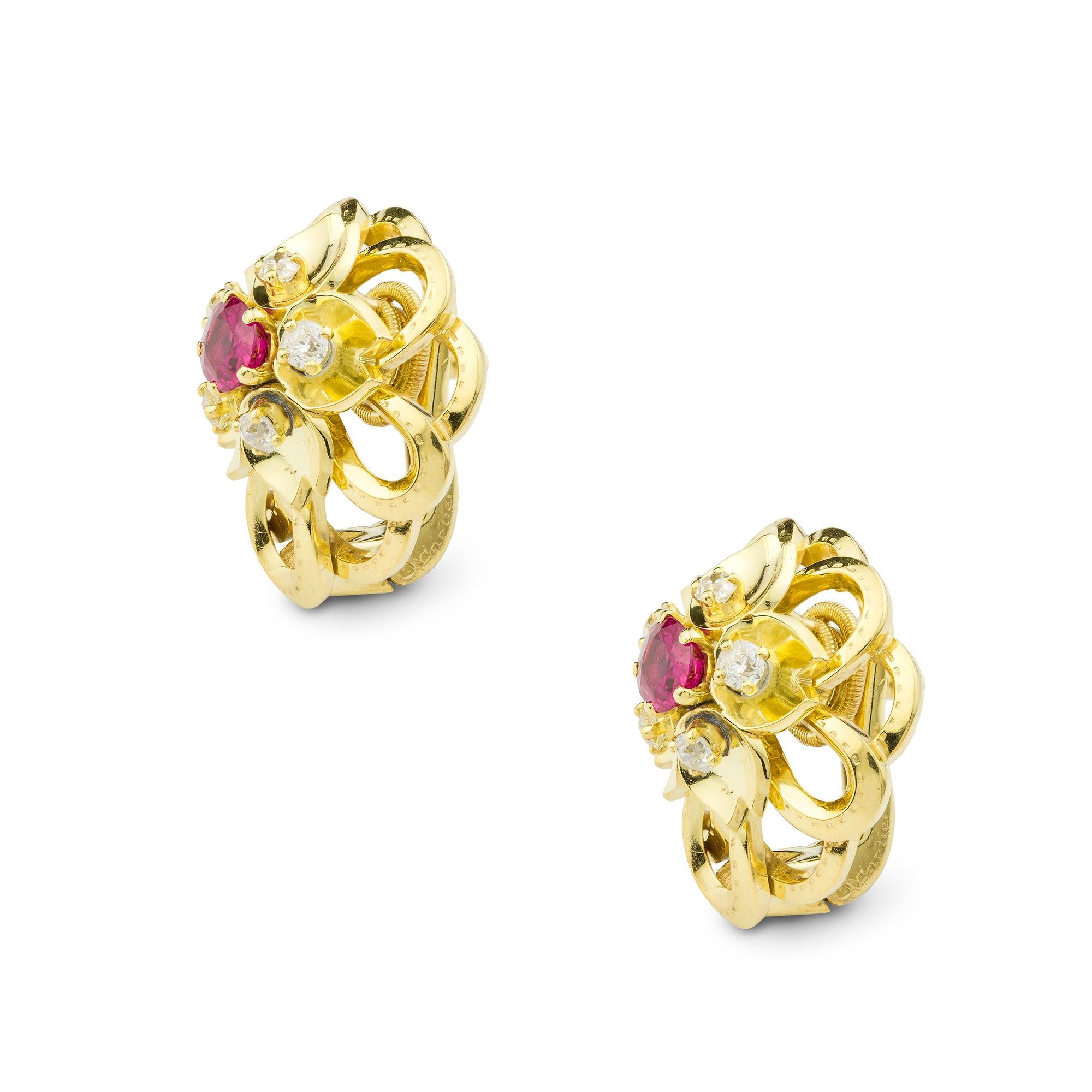 A pair of Cartier ruby and diamond flower earrings, centred with an oval-cut ruby estimated to weigh 1.20cts the pair surrounded by five brilliant-cut diamonds estimated weight 0.40cts the pair set in gold petals to gold openwork design, gross