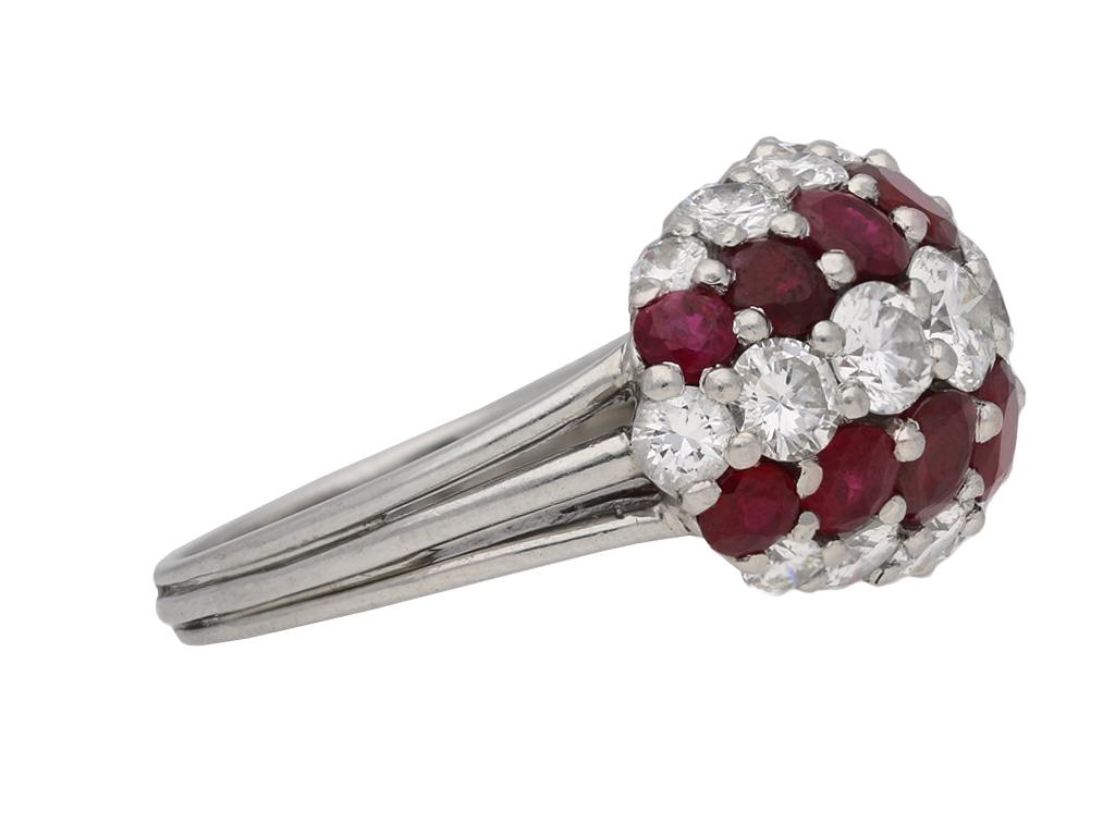 Ruby and diamond ring by Cartier. Set with sixteen round brilliant cut natural unenhanced rubies to two horizontally set tapered rows in open back grain settings with an approximate combined weight of 6.00 carats, alternated by three rows of tapered