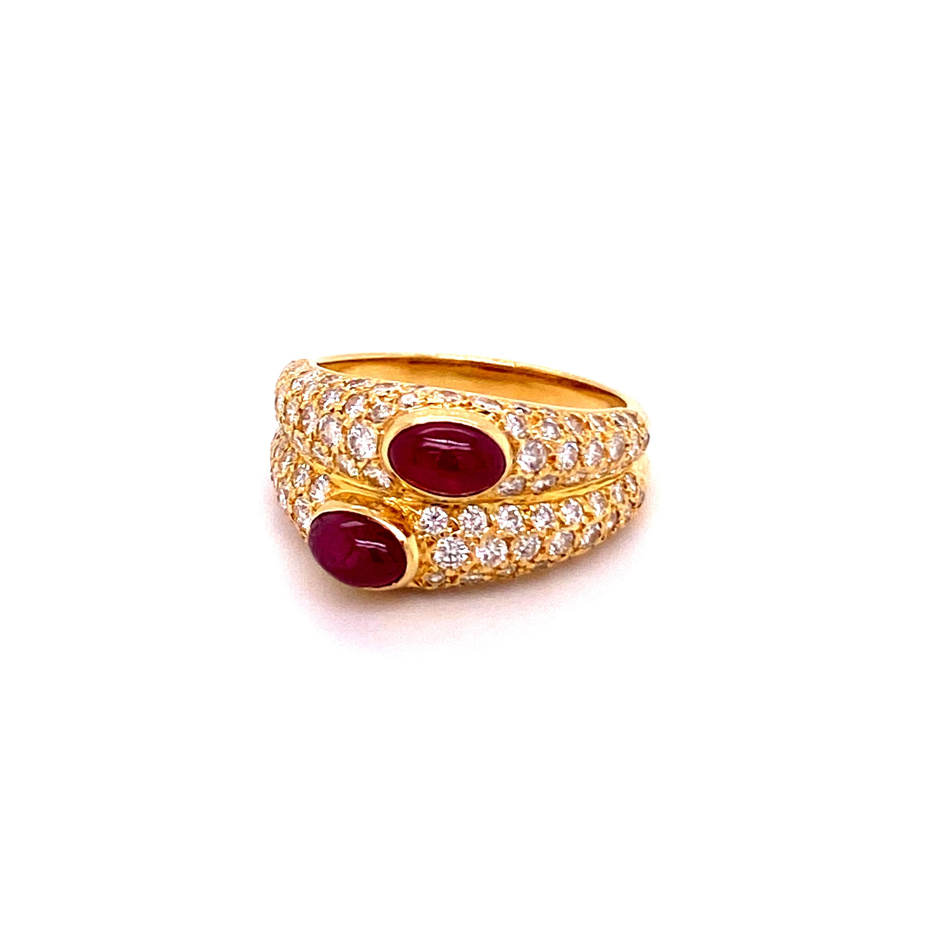 This superb ring by Cartier Paris features two oblong cabochon cut rubies of a lively and intense red color. Total weight of the rubies approximately 1.20 carats. Beautifully crafted mounting in 18 karat yellow gold, set with 100 brilliant cut