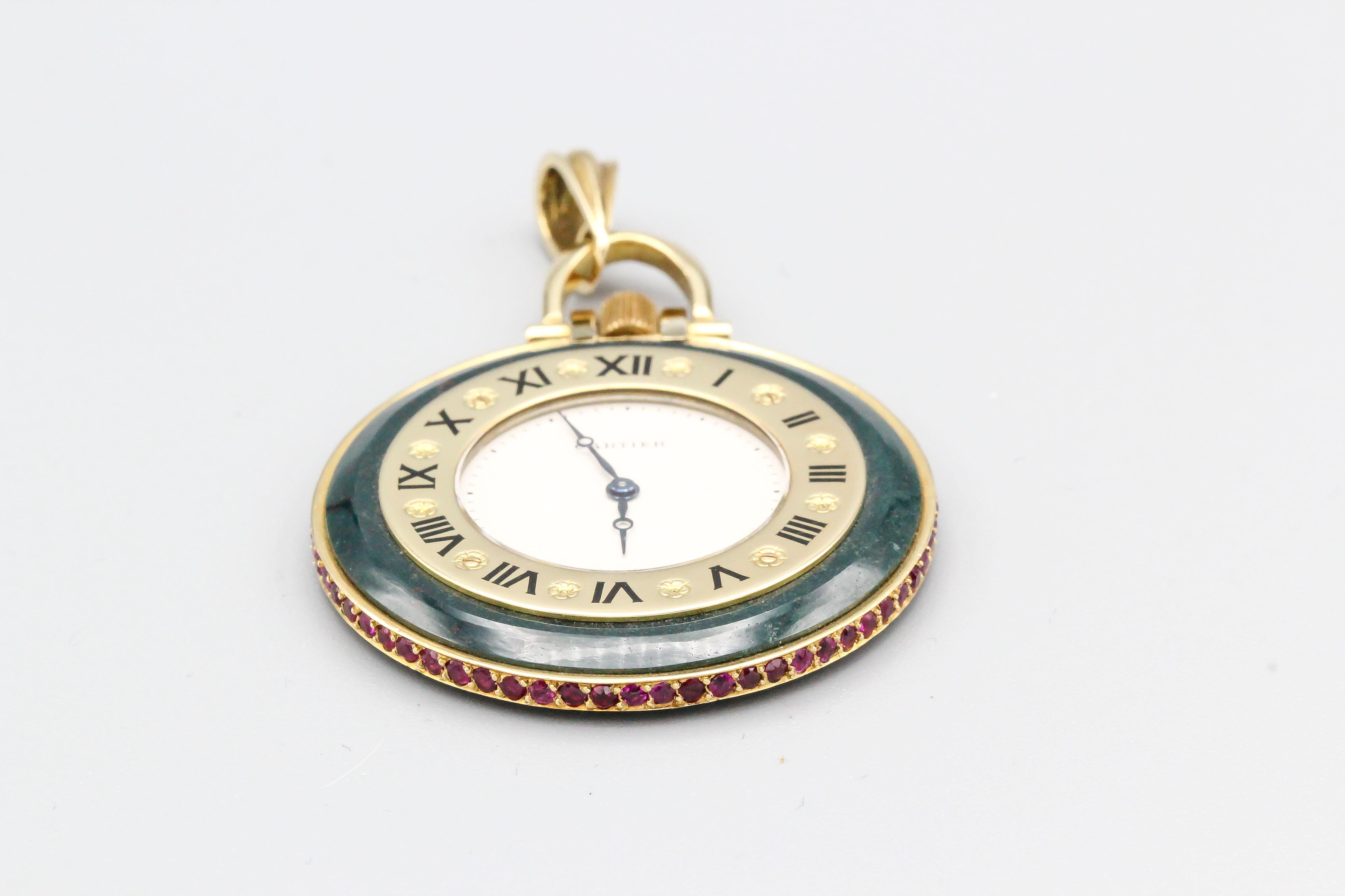 Elegant red ruby, bloodstone and 18K yellow gold pocket watch by Cartier. It features rich red rubies all around the outer diameter of the case, with bloodstone body and 18K gold accents. Quartz movement. Comes with original Cartier invoice showing