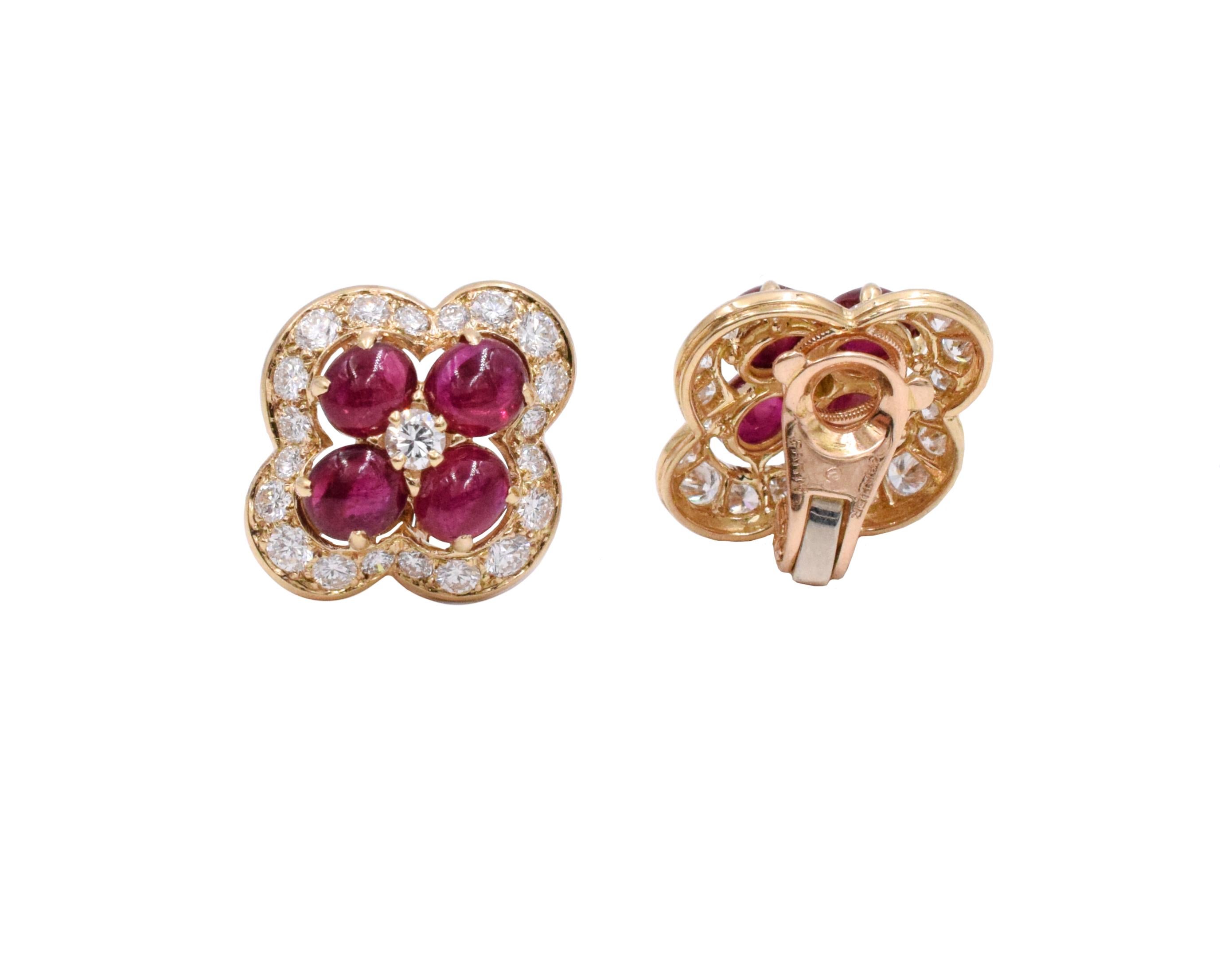 Cartier ruby and diamond ear clip earrings 
Earring set with two approximately 0.10ct round brilliant cut diamonds in the center. Surrounded by eight oval cabochon cut rubies  Border of the earrings set with 40 round brilliant cut diamonds weighing