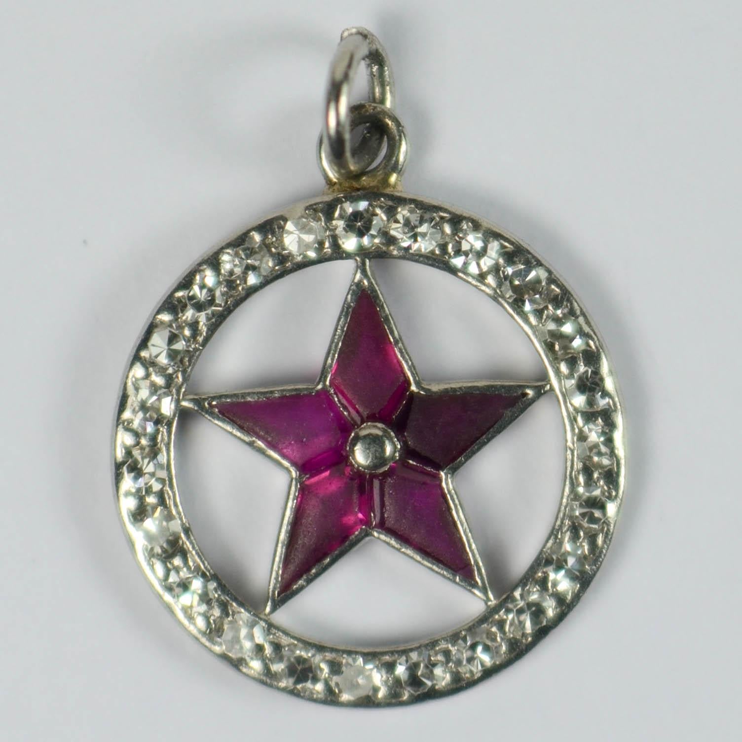 Cartier lucky star charm pendant in platinum set with five buff-top rubies to the star, encircled by a ring of diamonds. Signed Cartier in script to the edge of the circle with French marks. 5/8