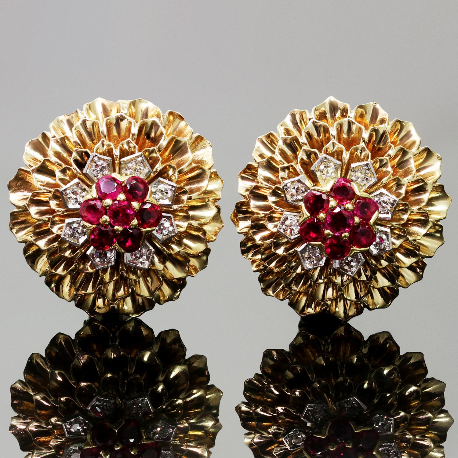 These fabulous circa 1960s Cartier 14k yellow gold clip-on earrings feature a vibrant cluster design set with sparkling red rubies of an estimated 1.00 carats and round diamonds of an estimated 0.30 carats. One earring is marked Cartier 14KT 18134.