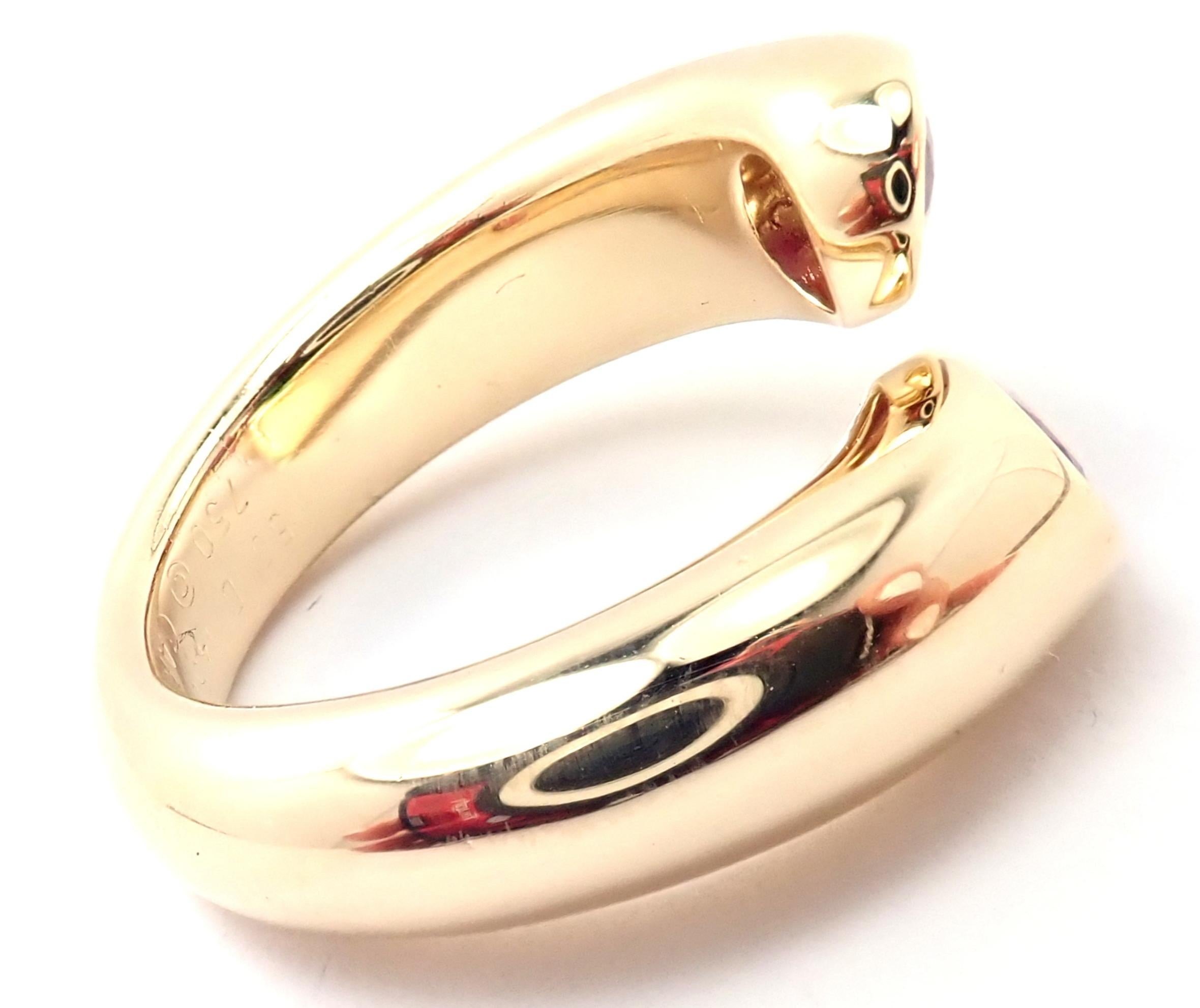 18k Yellow Gold Ellipse Deux Tetes Croisees Bypass Ruby Band Ring by Cartier.
With 2 oval cut rubies, approx 1.20ct
Metal: 18k Yellow Gold
Band Width: 9mm
Weight:   11.3 grams
Size:	5 1/2 US, Europe 50
Hallmarks: Cartier 750 50, 1995 D14505
YOUR