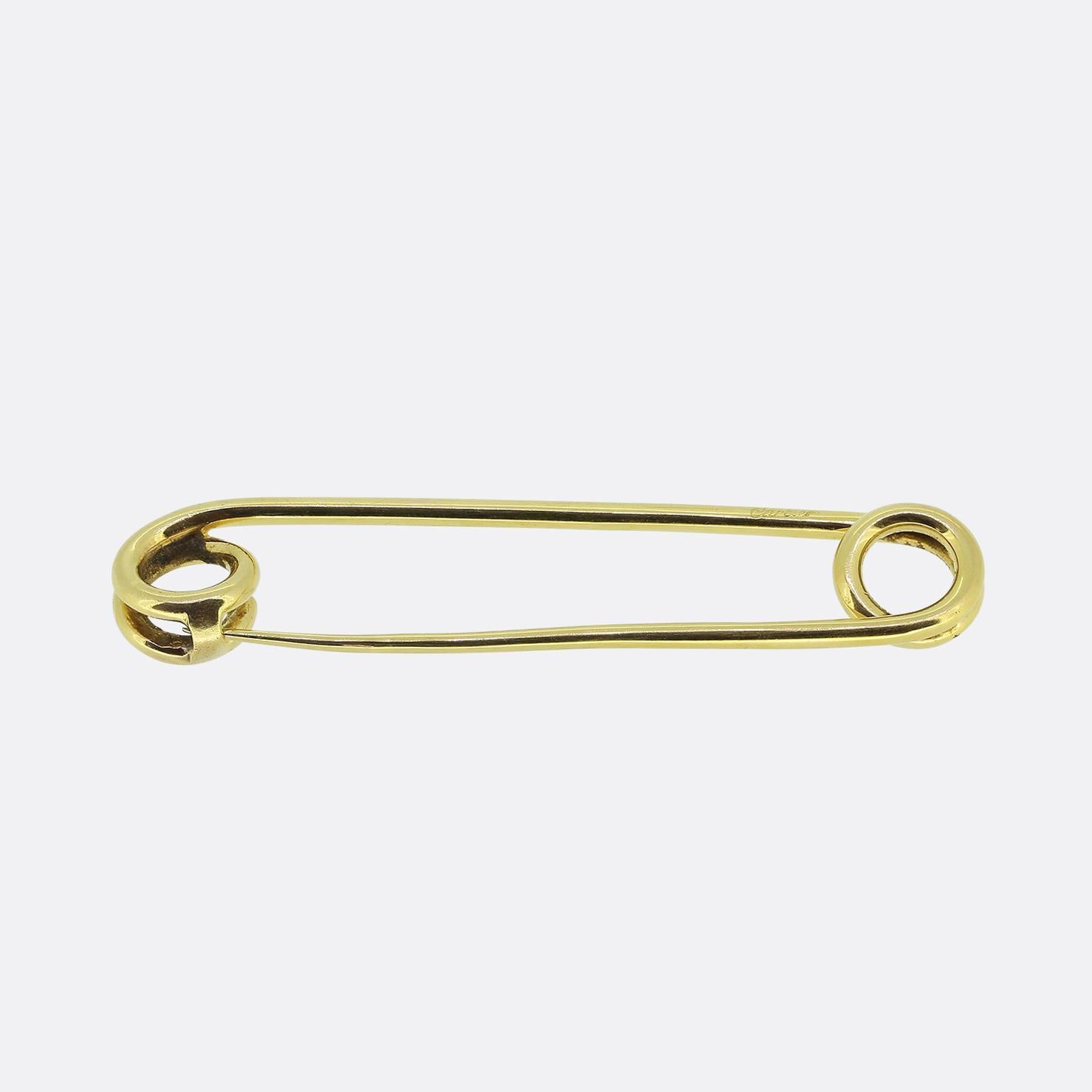 Hier haben wir eine Vintage-Anstecknadel aus dem weltbekannten Luxusschmuckhaus Cartier. Dieses Stück wurde aus warmem 18-karätigem Gelbgold in der Form einer klassischen Sicherheitsnadel gefertigt. Cartier ist bekannt dafür, alltägliche Gegenstände