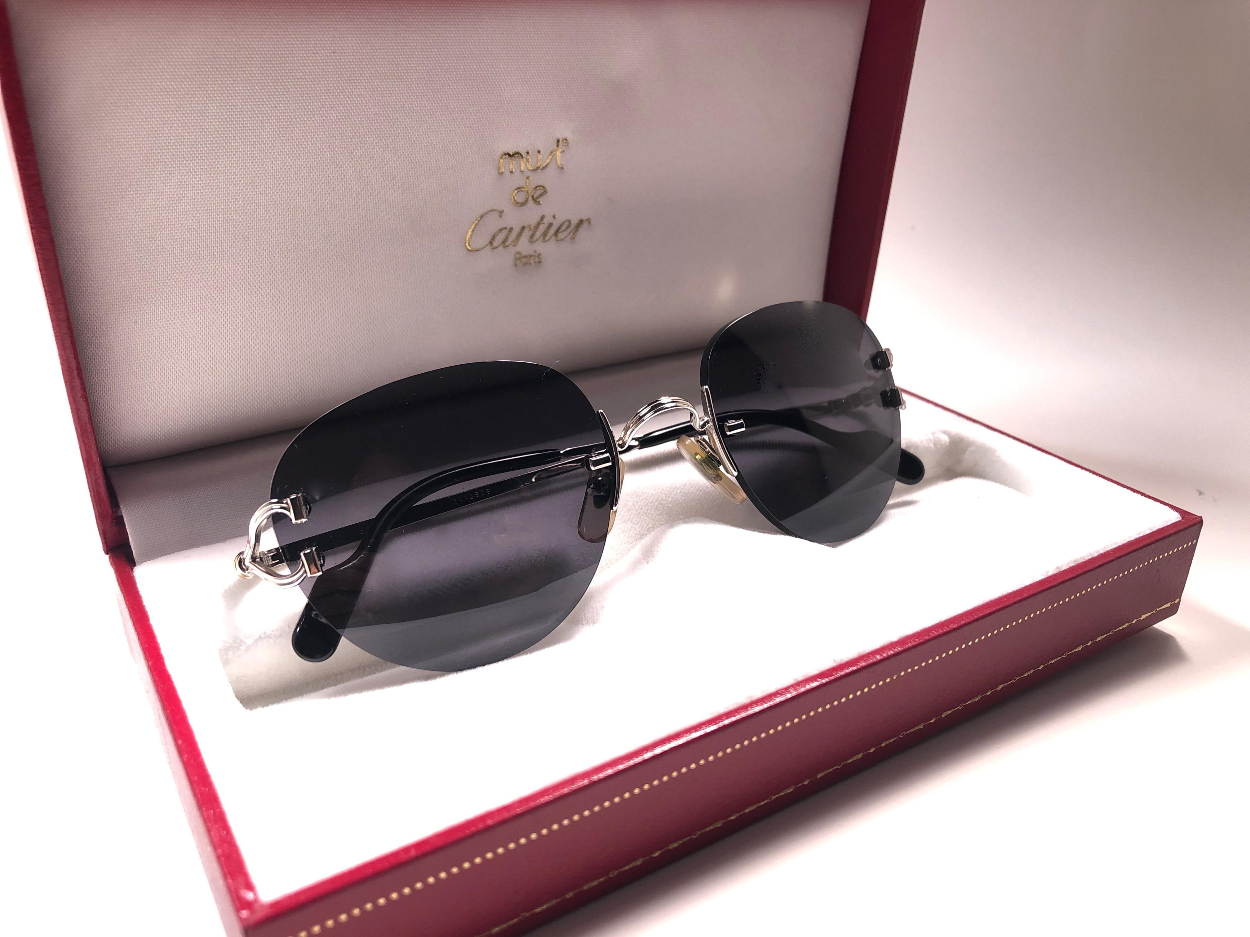 New Cartier Salisbury unique rimless sunglasses with Grey G15 (uv protection) lenses.  Frame with the front and sides in special edition platine. All hallmarks. Cartier gold signs on the ear paddles.  These are like a pair of jewels on your nose. 