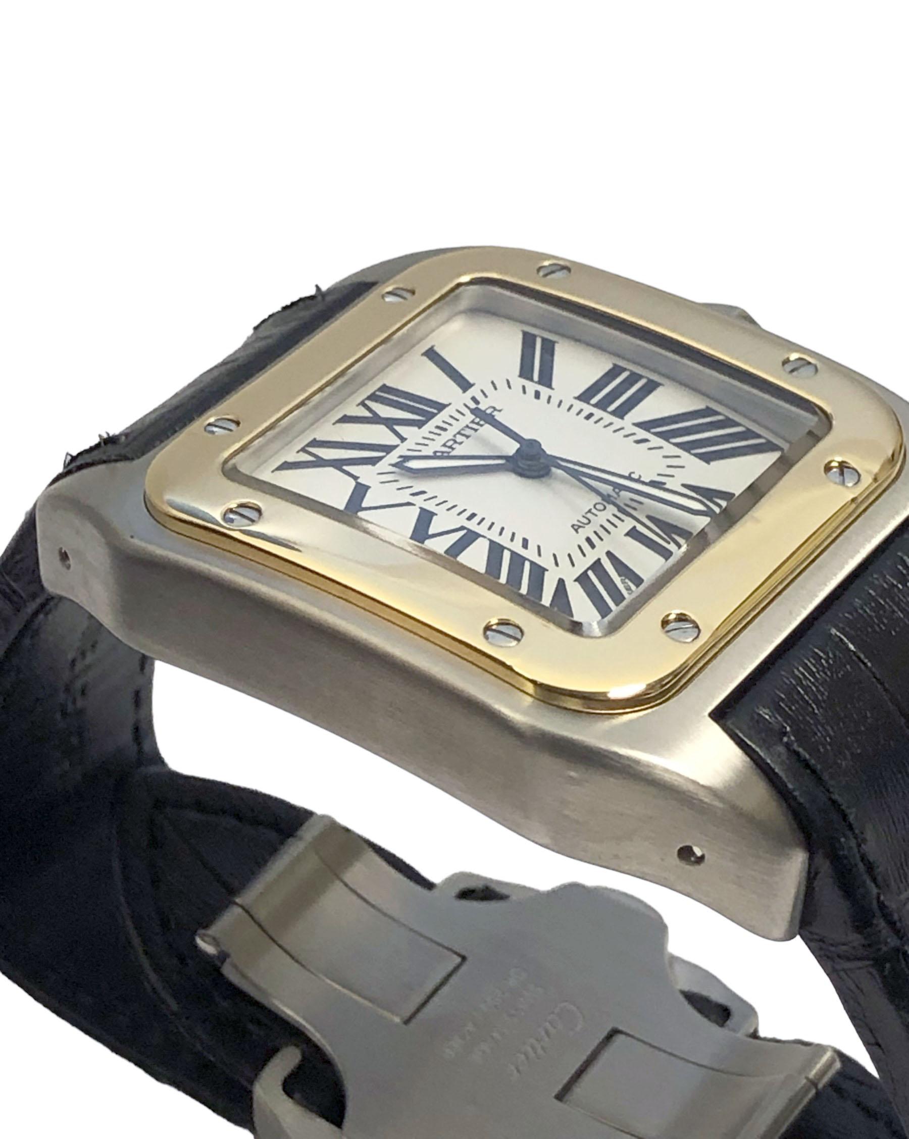 Circa 2015 Montre-bracelet Cartier Santos 100, référence 2656, 36 X 39 M.M. Boîtier en acier inoxydable résistant à l'eau, lunette en or jaune 18 carats, couronne sertie de saphirs, mouvement automatique, cadran argenté satiné avec chiffres romains