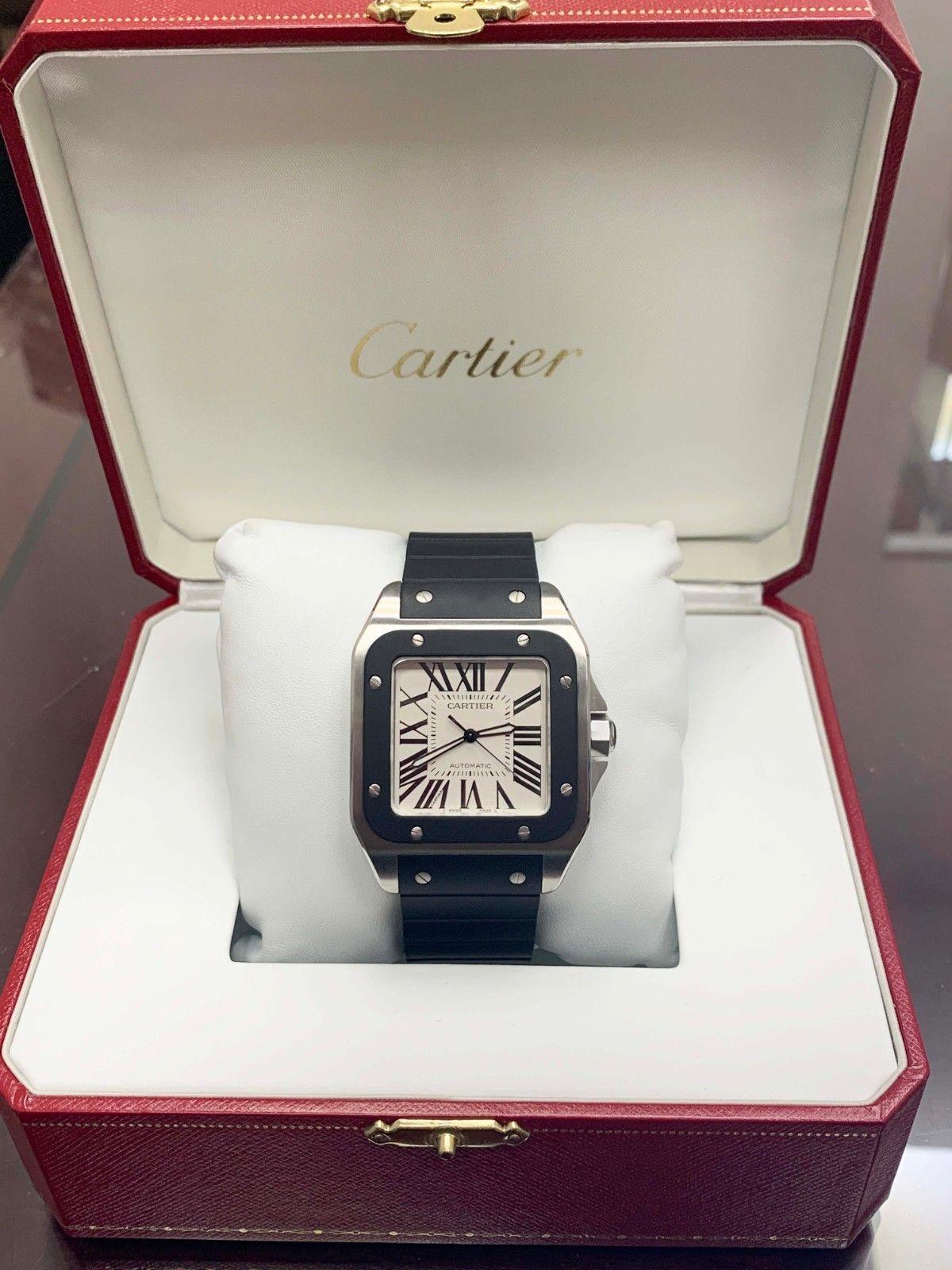 Reference Number: 3774
Model: Santos 100
Case Material: Stainless Steel 
Band: Black Rubber
Bezel: Black Rubber 
Dial: Ivory / White 
Face: Sapphire Crystal 
Case Size: 38mm (without Crown) 
Includes: 
-Cartier Box & Papers
-Certified Appraisal 
-6