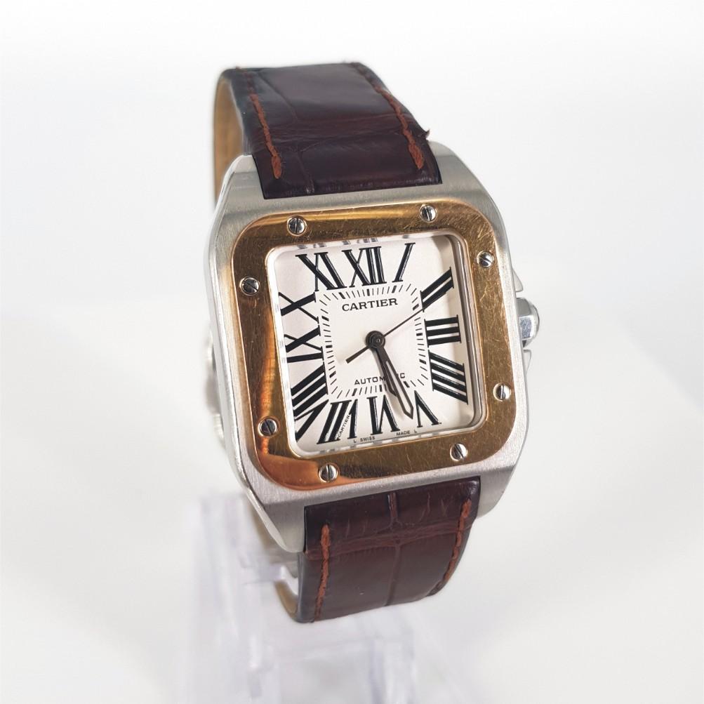 Cartier Santos 100 Watch – Automatic in Excellent condition. 
Serial Number: 251576NX  & Model Number: 2878
Stainless Steel & Gold Case measuring 33mm with a Silver Dial & Alligator Strap measuring 55mm with Box.

