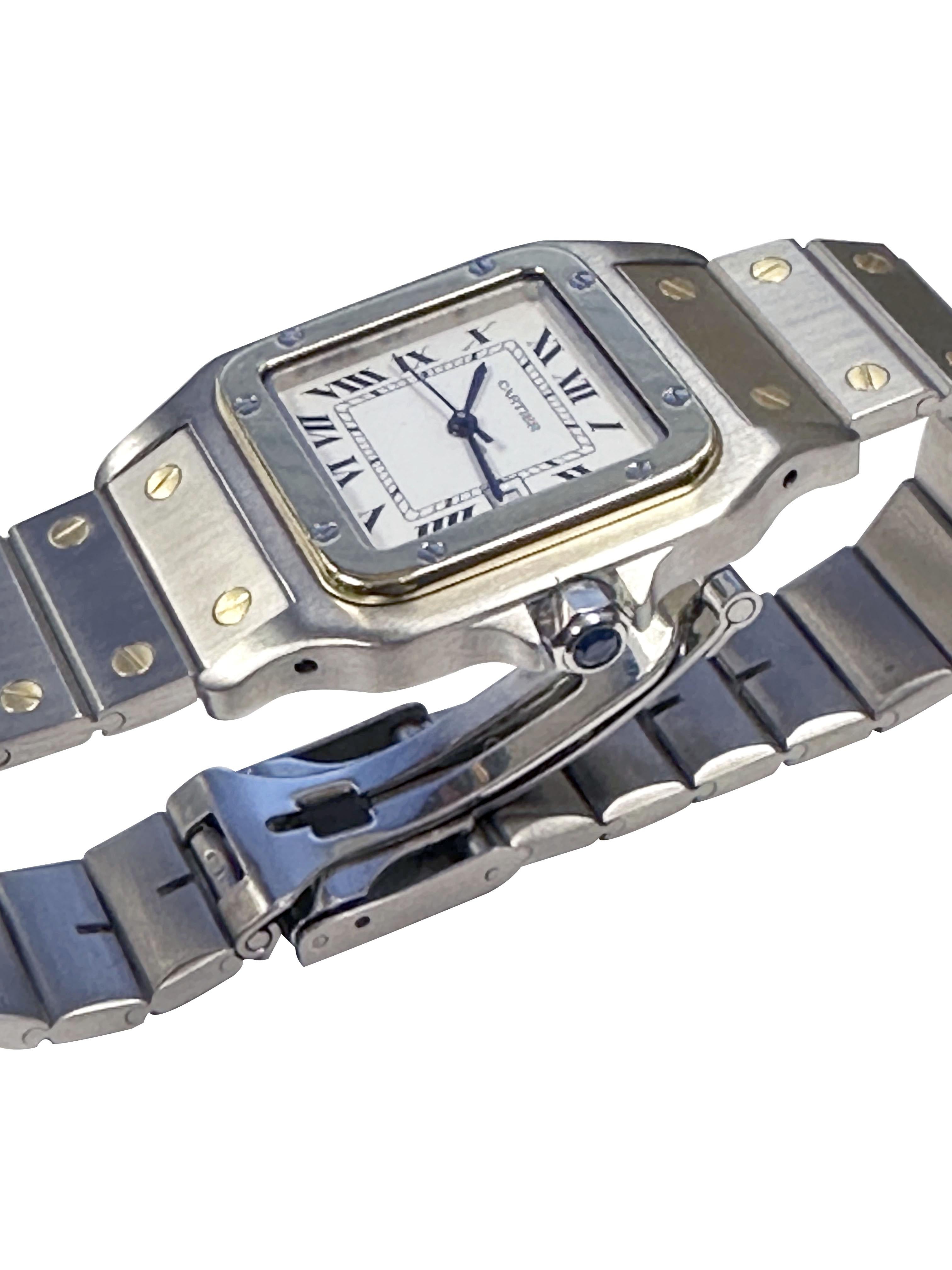 Circa 2000 Cartier Santos Gold and Steel Wrist Watch 29 x 27 M.M Stainless Steel case with 18K Yellow Gold Bezel and a Sapphire Crown, Automatic Self winding Movement, White Dial with Black Roman Numerals a Calendar window at the 3 position, sweep