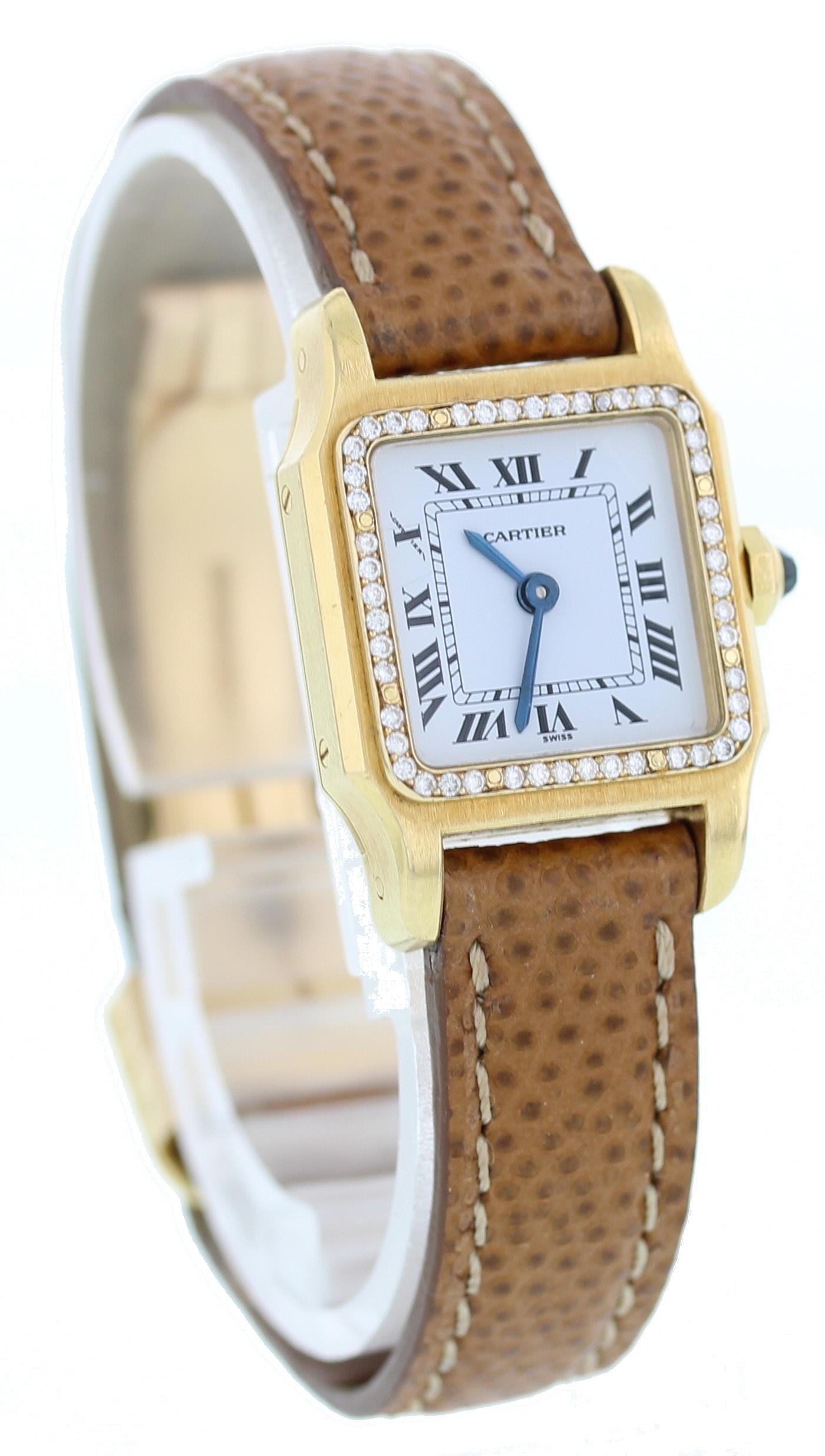Cartier Paris Santos. 18k Yellow Gold 20mm case. 18k yellow gold bezel with custom set diamonds. White dial with blue hands and Roman numeral markers. Brown leather Cartier strap with an 18k yellow gold deployment clasp. Will fit 6 inch wrist.