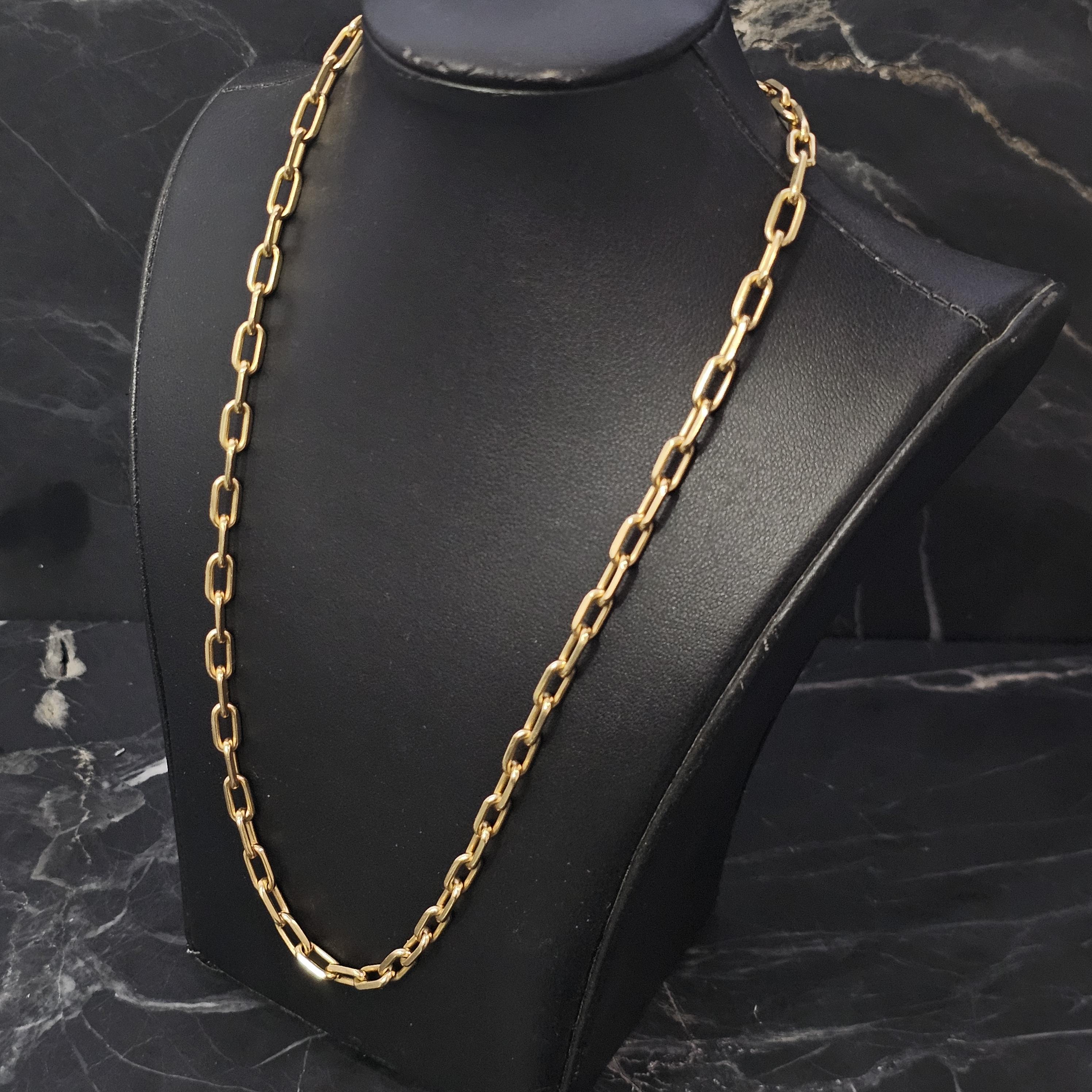 This Cartier Santos chain necklace is a refined piece for jewelry enthusiasts. Crafted from 18k yellow gold, it features a classic link design. The necklace measures 24 inches in length and 5 mm in width, offering a substantial yet elegant presence.