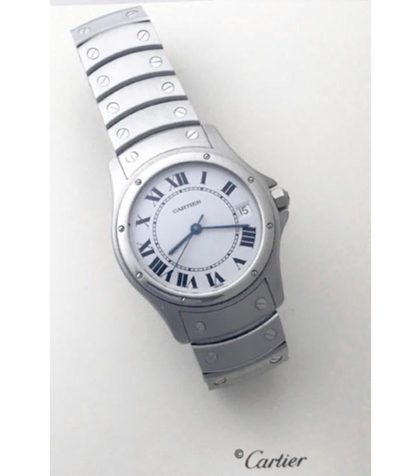 Charming and timeless. This beautiful Cartier Santos is in gorgeous condition. This watch features stainless steel construction. The dial is a silver textured dial that features black Roman numerals and blued hour and minute hands. The stainless