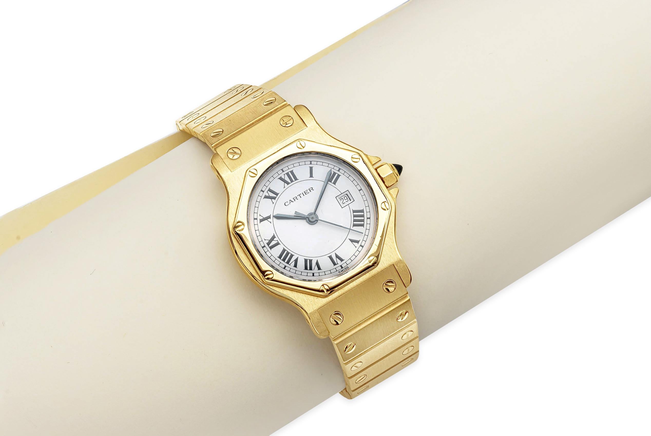 Cartier Santos Automatique.
Case: Octagonal case measuring 30mm in diameter. Made in 18k yellow gold.
Bezel: Screwed design made in 18k yellow gold.
Back: Screw-down back engraved 