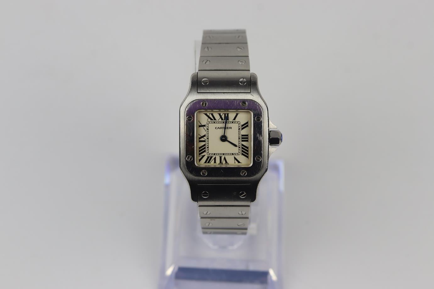 Cartier Santos de Cartier Galbée small stainless steel wrist watch. Silver stainless steel. Quartz movement. Fixed bezel. Silver dial. Butterfly clasp. Comes with box, 5 additional wrist links, certificate and handbook. Case Diameter: 23 mm. Case