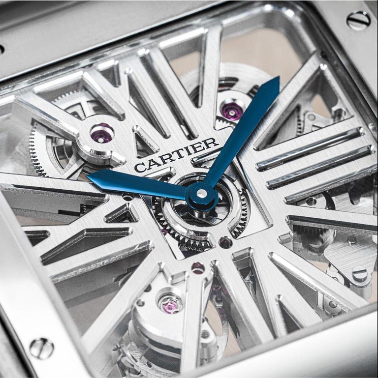 A large Santos Skeleton wristwatch by Cartier in stainless steel. Features a striking skeleton dial with skeletonised bridges forming roman numerals, blue steeled sword-shaped hands and a stainless bezel set with the 8-screw design.

Fitted with a