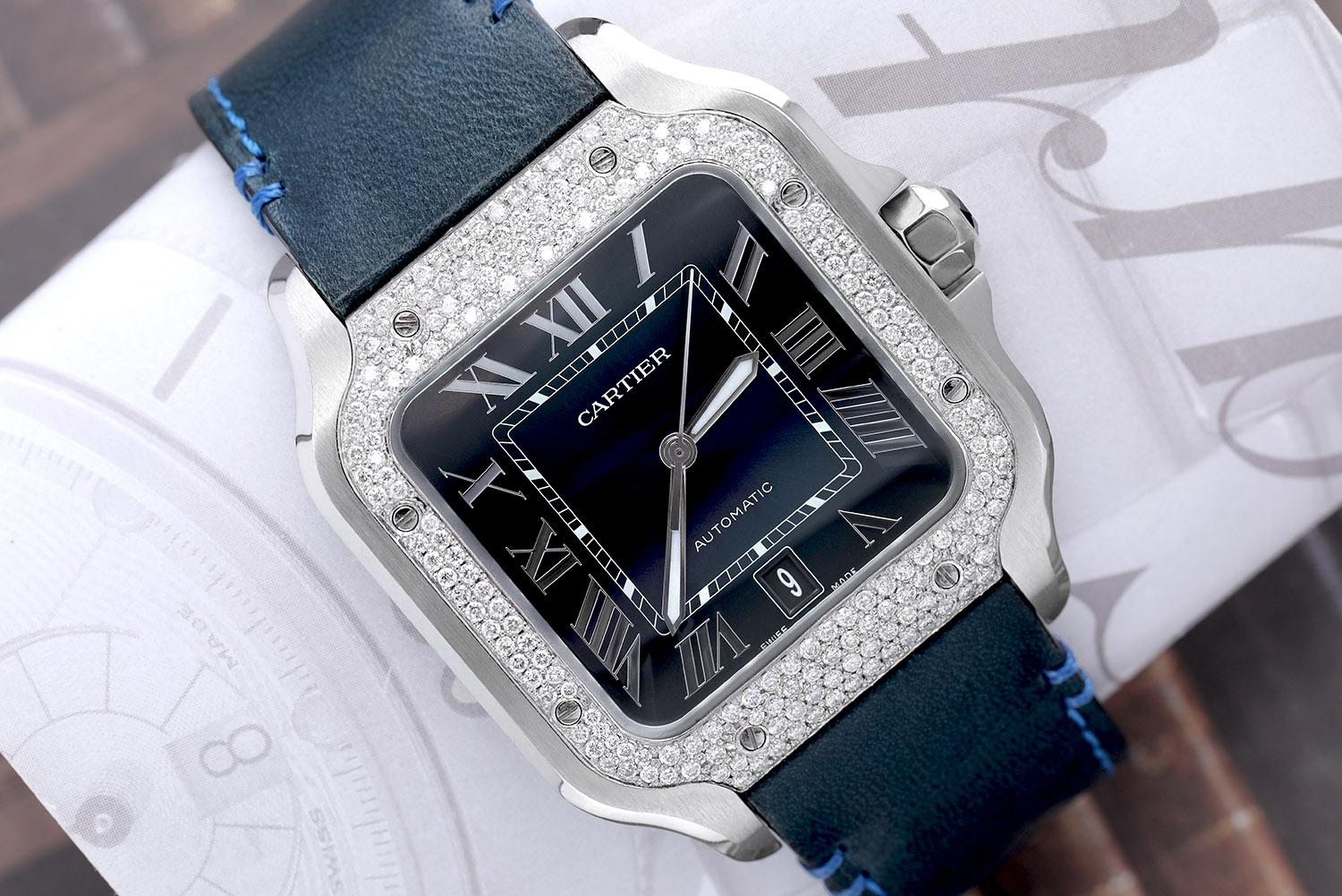Cartier Santos Large Stainless Steel Watch with Custom Diamond Bezel, Blue Roman Numeral Dial (factory) and Blue Leather Band. 
WATCH COMES WITH AN ADDITIONAL Stainless Steel Bracelet! Mechanical movement with automatic winding, caliber 1847 MC.