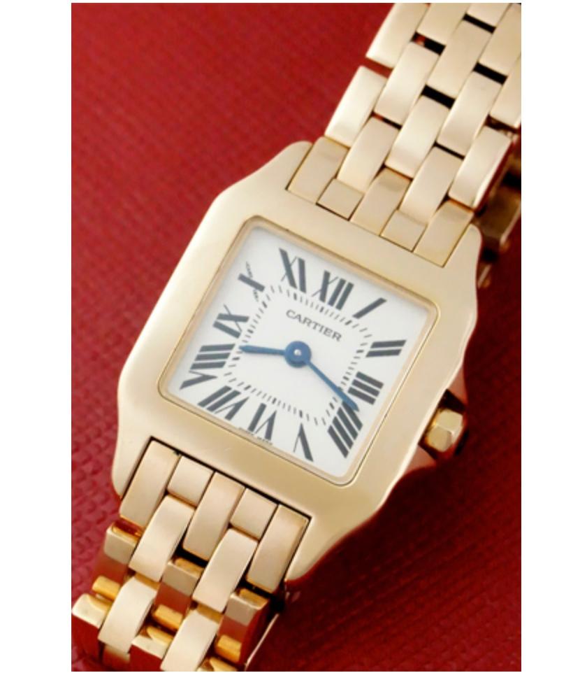 Gorgeous 18k rose gold Cartier Santos DeMoiselle. The watch features a silver dial with black Roman numerals and blued hour and minute hands all cased in 18k rose gold. Powered by a quartz movement, this watch also features a 18k rose gold crown