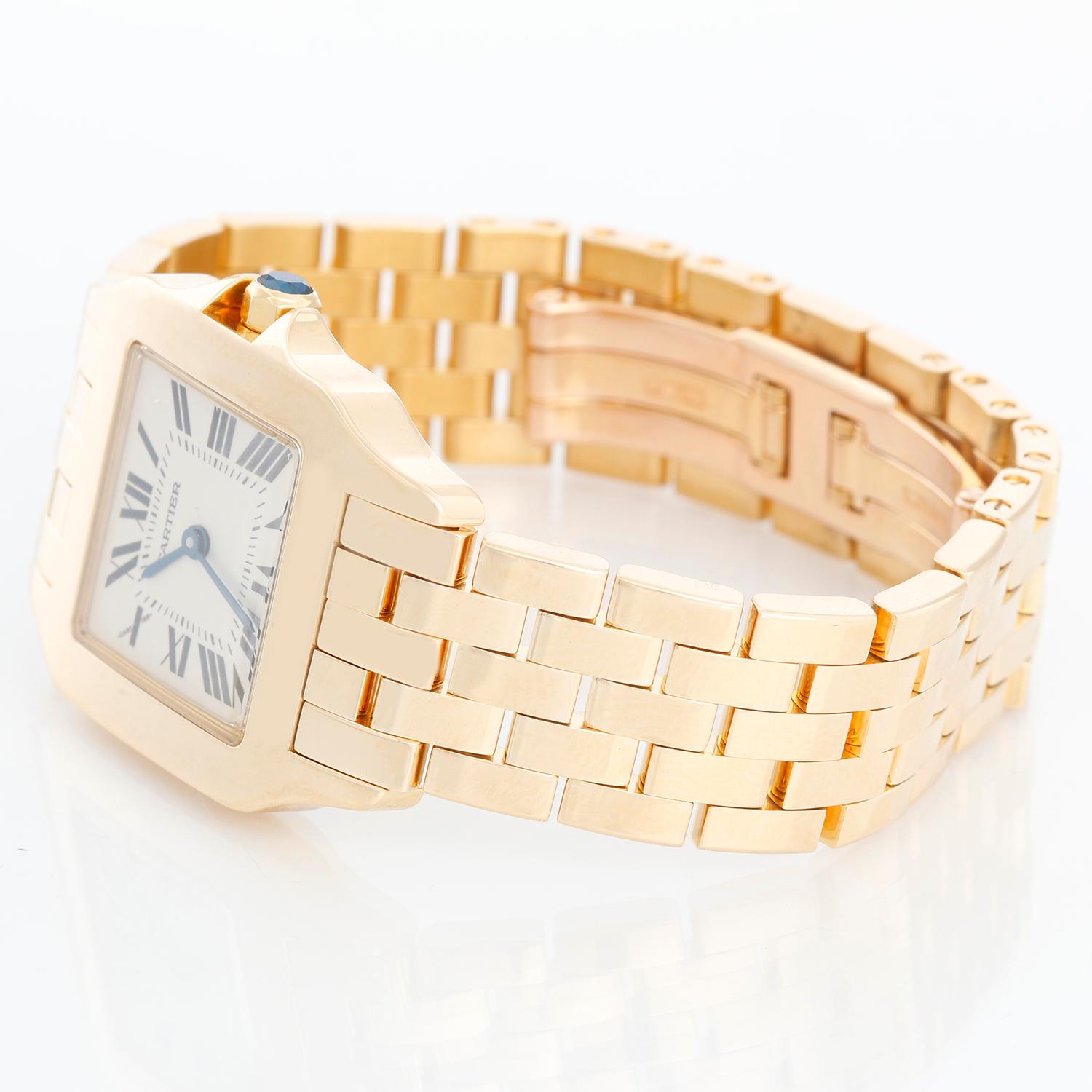 Cartier Santos Demoiselle 18k Yellow Gold Midsize Watch 2702 - Quartz. 18k yellow gold case (26mm x 38mm). Ivory colored dial with black Roman numerals. 18k yellow gold Cartier bracelet with deployant clasp. Pre-owned with Cartier box.