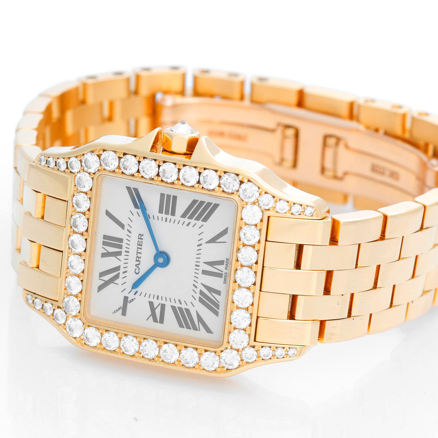 Cartier Santos Demoiselle 18k Yellow Gold Midsize Watch WF9002Y7 - Quartz. 18k yellow gold case with a diamond bezel and lugs  (26mm x 38mm). Ivory colored dial with black Roman numerals. 18k yellow gold Cartier bracelet with deployant clasp.