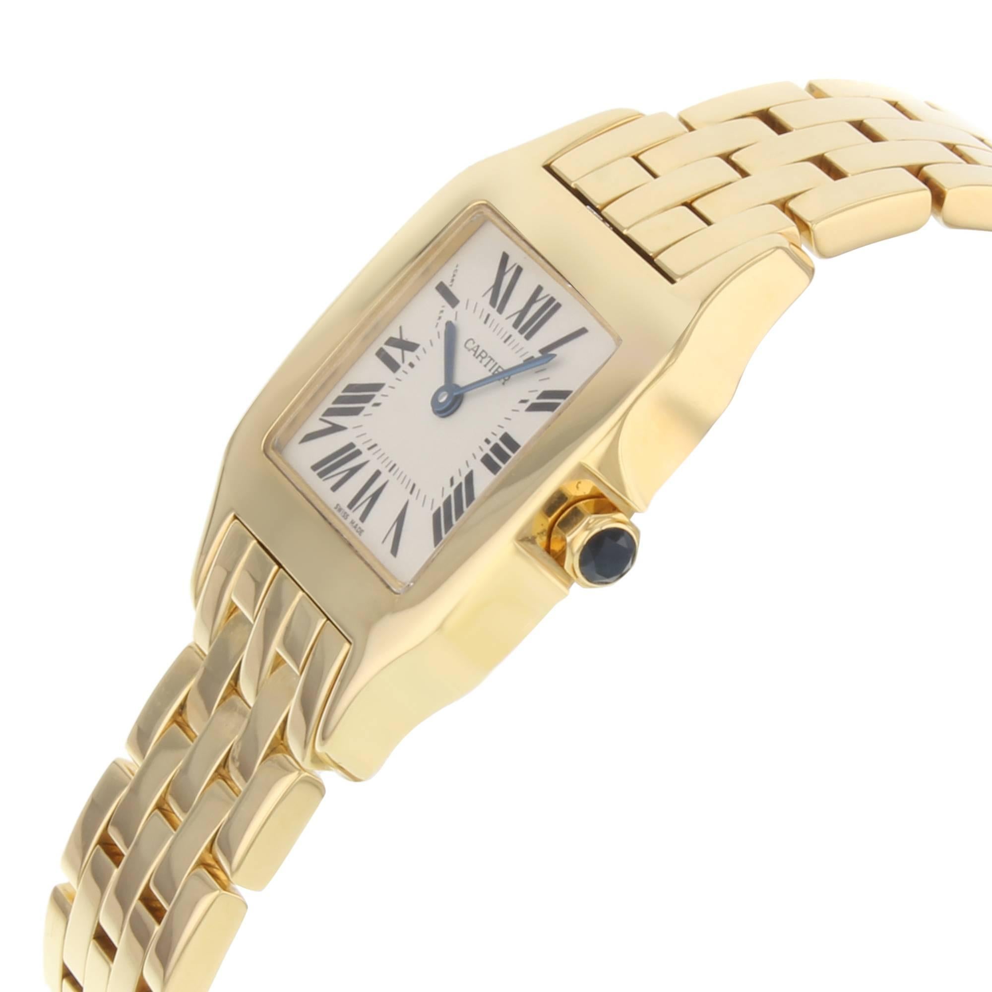This  never been worn  Cartier Santos W25062X9  is a beautiful Womens timepiece that is powered by a quartz movement which is cased in a yellow gold case. It has a square shape face,  dial and has hand roman numerals style markers. It is completed