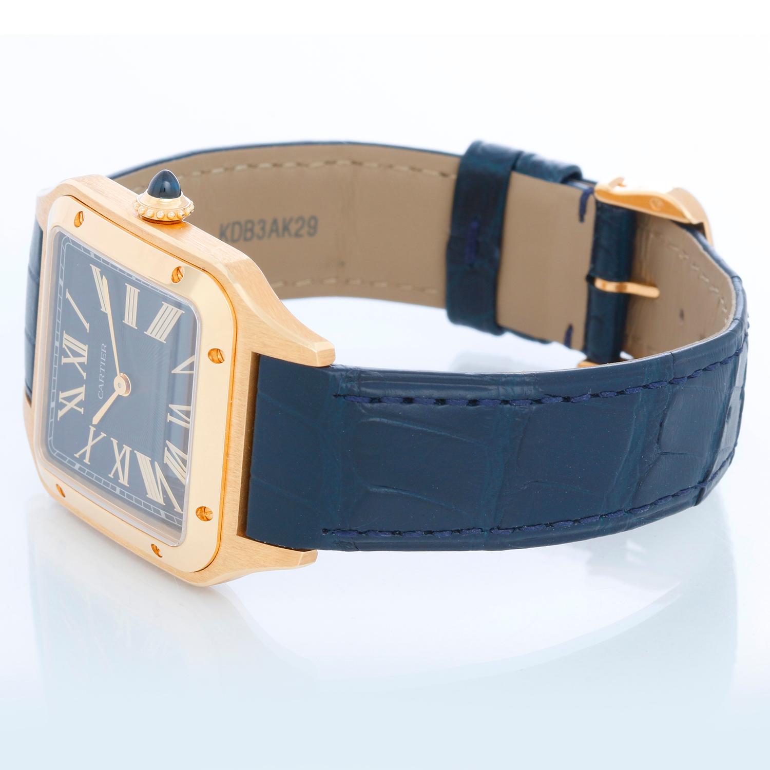 Cartier Santos Dumont 18k Yellow Gold WGSA0077 4532 - Quartz. 18k yellow gold square case (31 mm x 42 mm). Blue  Dial with Roman numerals. Blue Cartier alligator strap with 18k yellow gold tang buckle. Pre-owned with Cartier box, books and card.