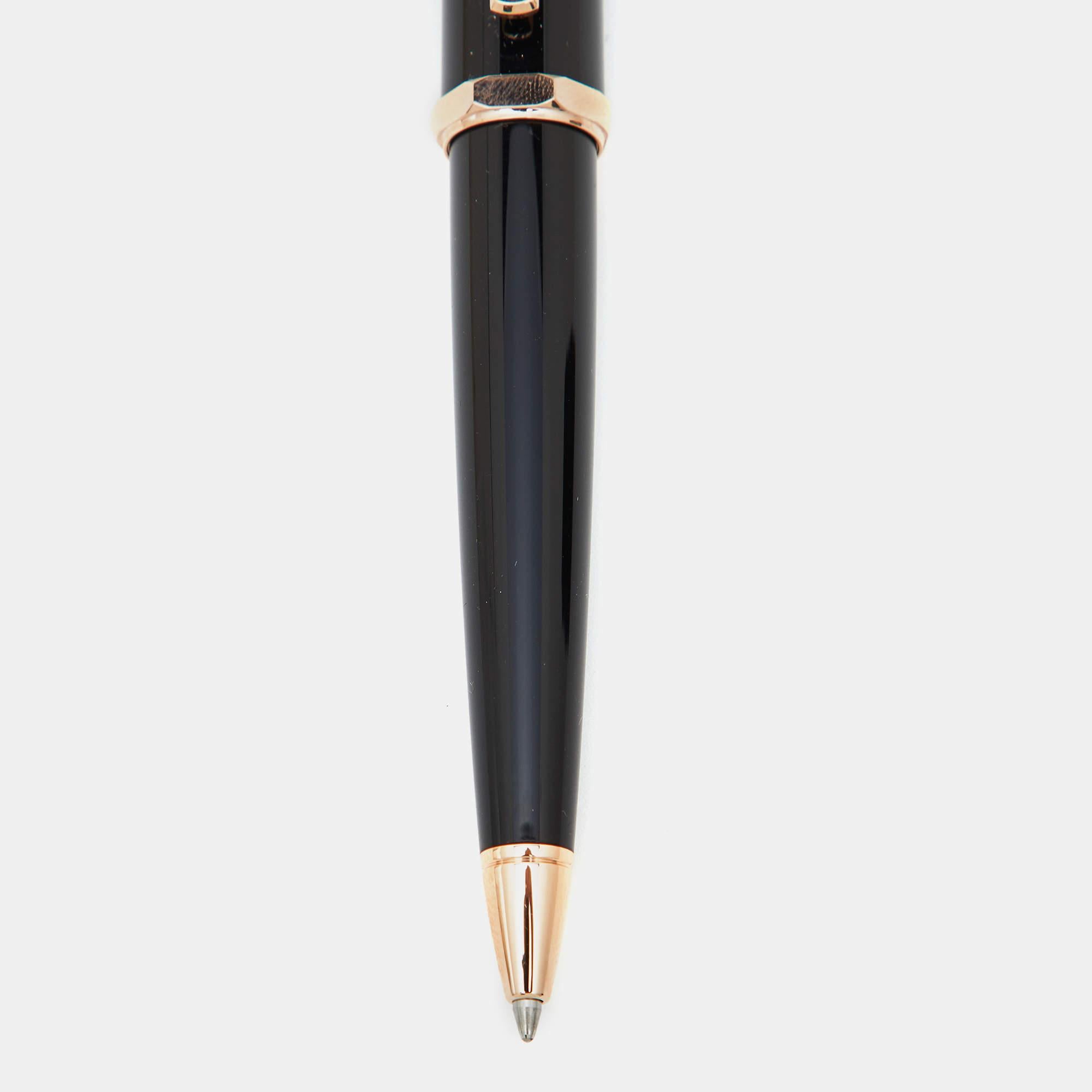 Cartiers Santos Dumont ballpoint pen in resin and gold tone metal is defined by quality craftsmanship. It has a sleek shape and just the right details to achieve a luxurious finish.
