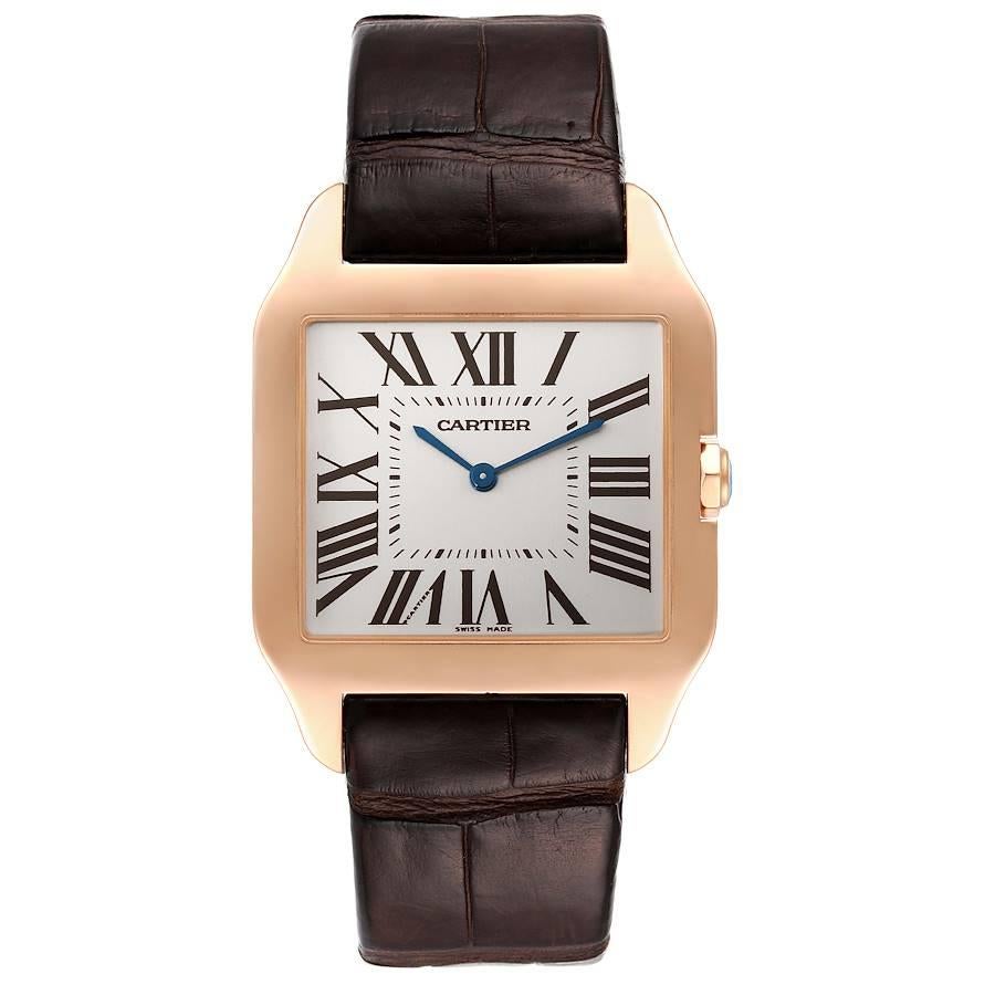 Cartier Santos Dumont Large 18k Rose Gold Mens Watch W2020034. Manual winding movement. 18k rose gold case 44.6 x 34.6 mm. Circular grained crown set with faceted sapphire. . Scratch resistant sapphire crystal. Silver dial. Painted roman numerals.