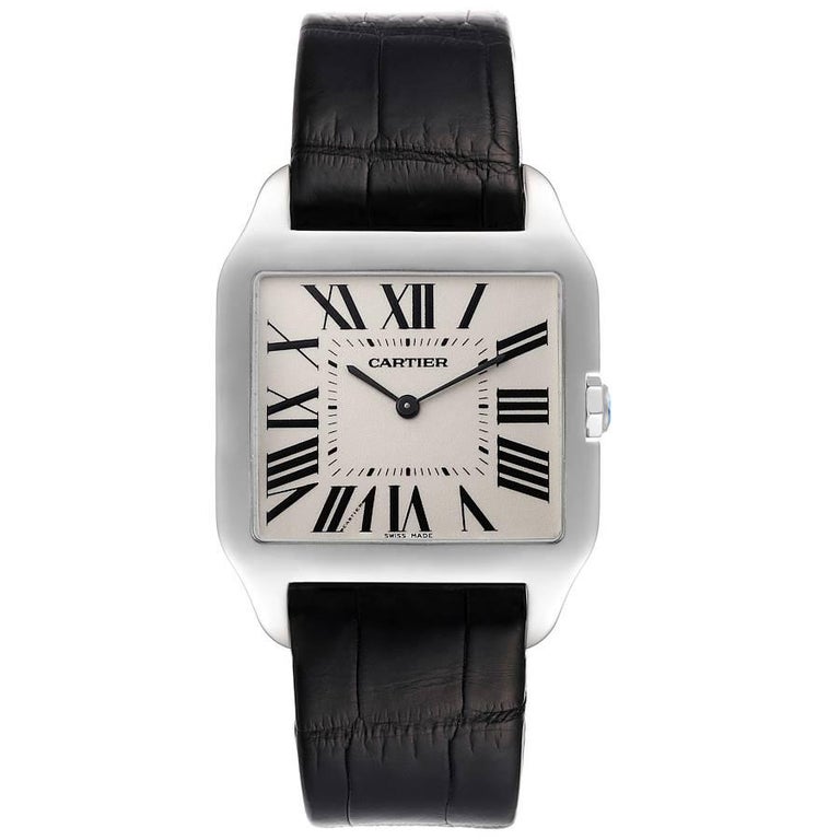 Cartier Santos Dumont Mens 18k White Gold Silver Dial Mens Watch W2007051. Manual winding movement. 18k white gold case 29 x 35 mm. Circular grained crown set with faceted sapphire. . Scratch resistant sapphire crystal. Silver dial. Painted black