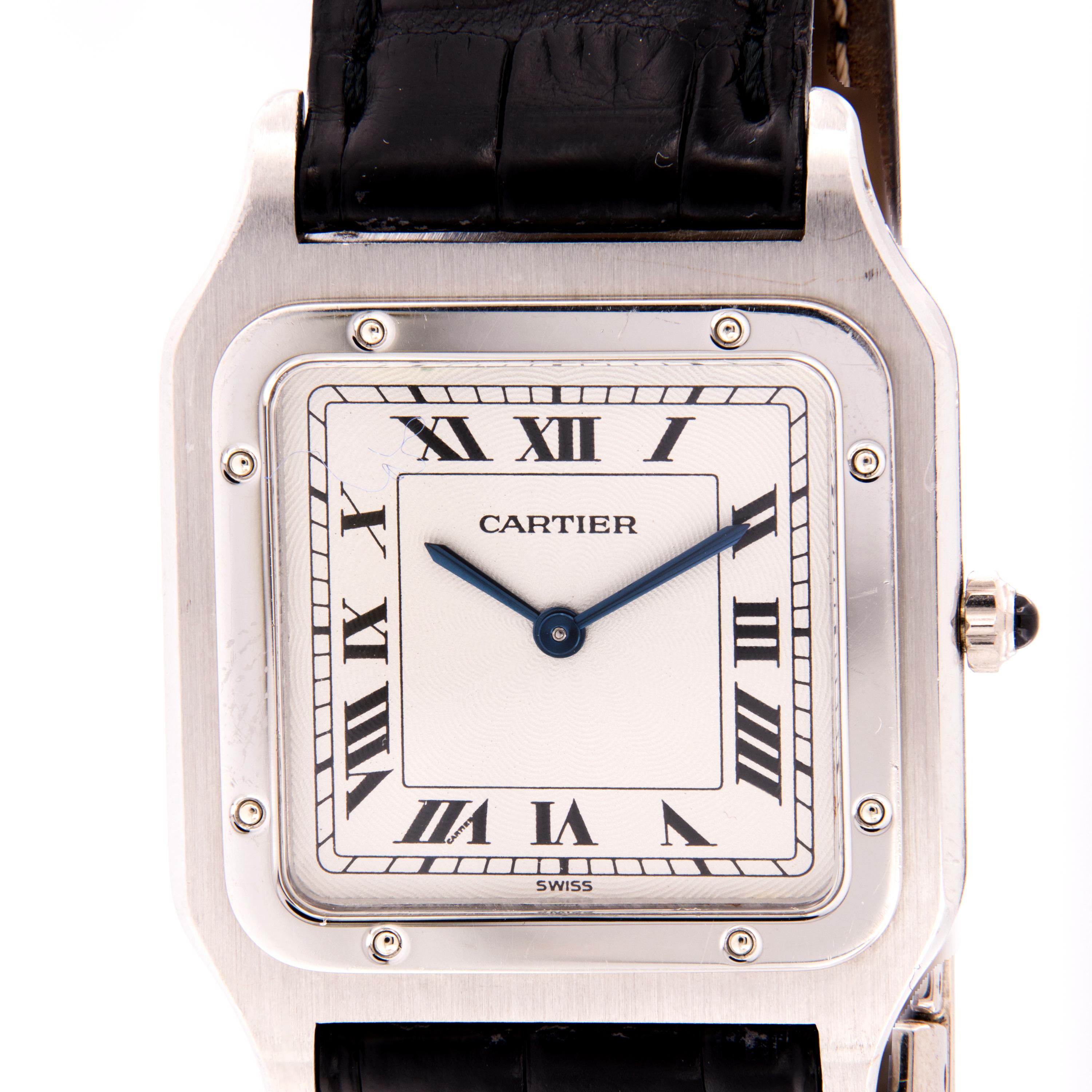 This is a pre-owned Hand-wound Cartier Santos Dumont unisex 1575 watch is in excellent condition. 27mm by 36mm case size in platinum, white roman dial on a back crocodile leather strap. This timepiece is very rare and still has the original strap