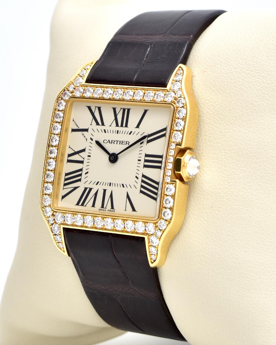 Brand: Cartier
Model: Santos Dumont 
Movement: Automatic
Case Size: 44.6 x 34.6 mm
Stone: Round Cut Diamonds (Custom)
Dial: Roman Numeral
Case Material: Rose  Gold
Bracelet Material: Rose Gold
Crystal: Scratch-Resistant Sapphire Glass
Includes: 24